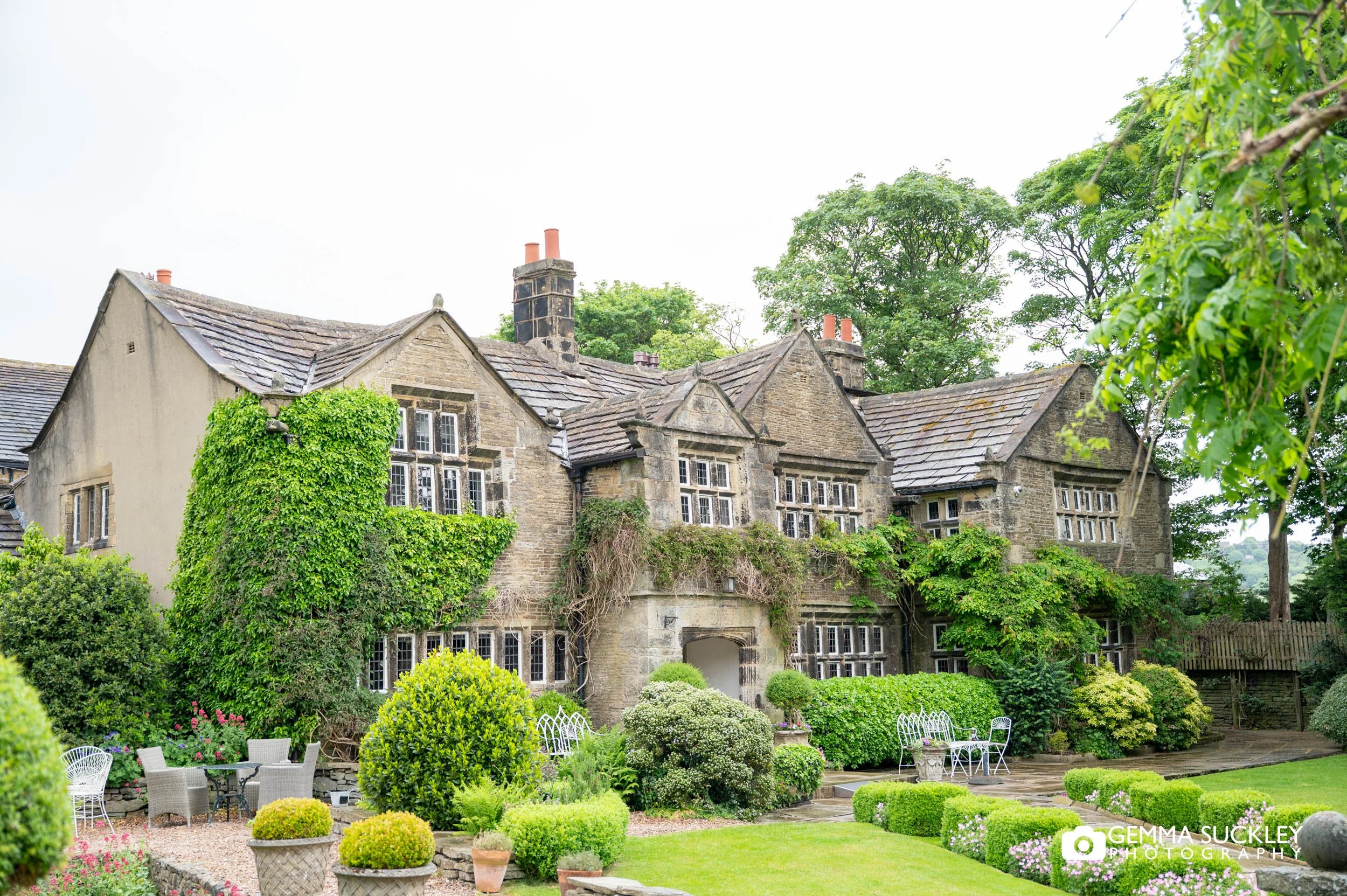 Historic manor house exterior at Holdsworth House surrounded by gardens