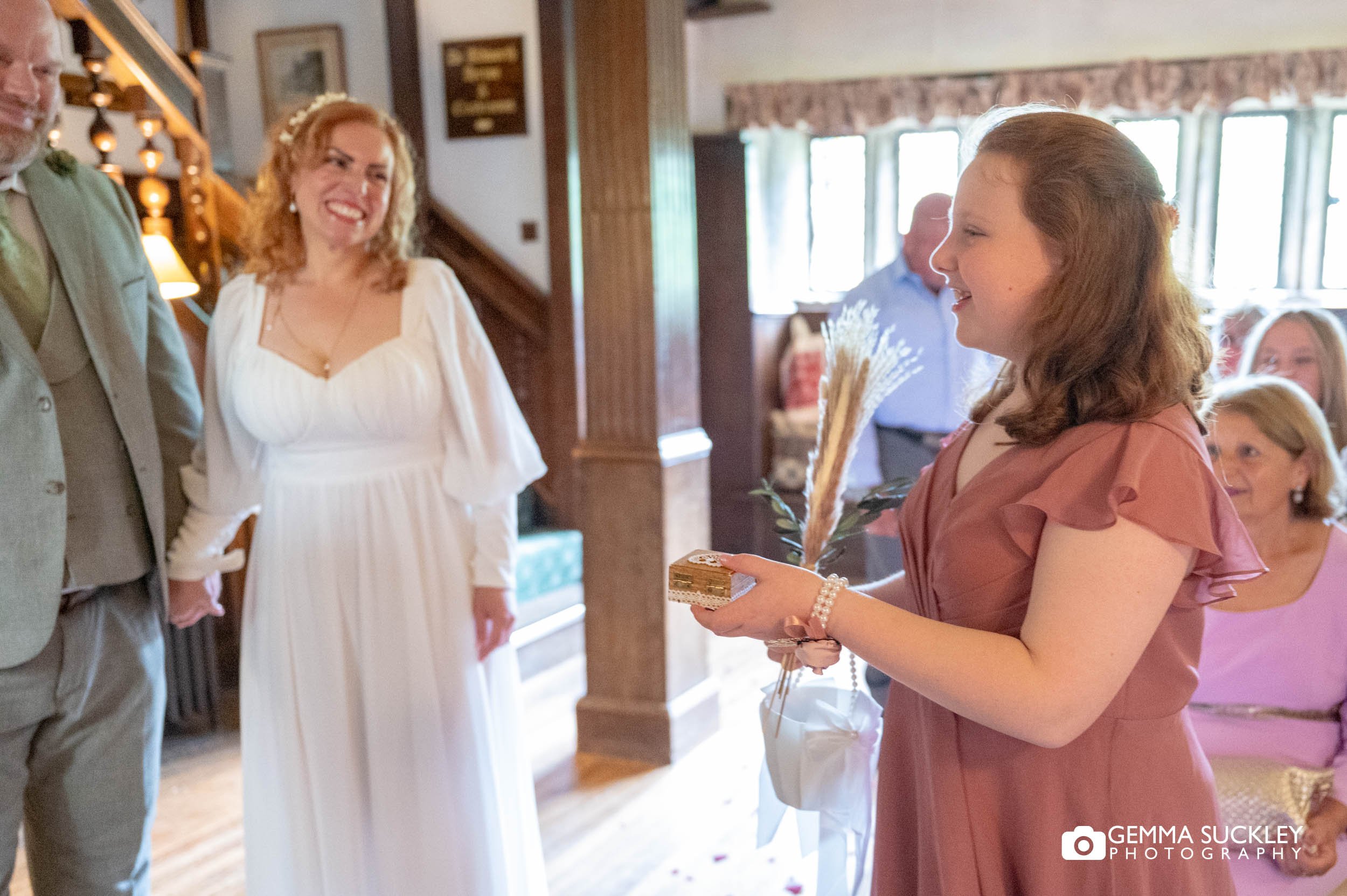 couples daughter bring forward the rinds at holdsworth house wedding