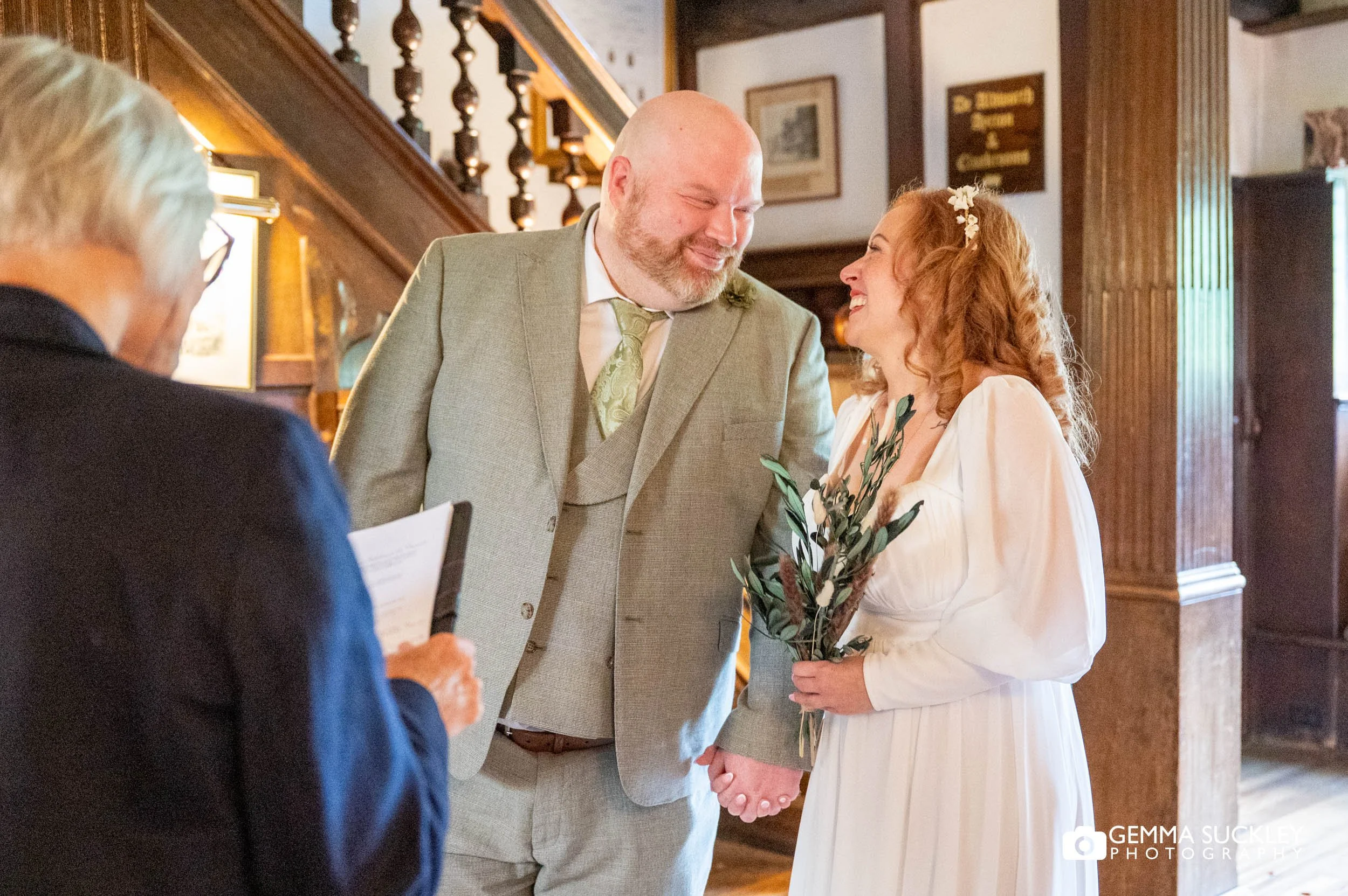 Bride and groom saying their vows in a relaxed indoor ceremony