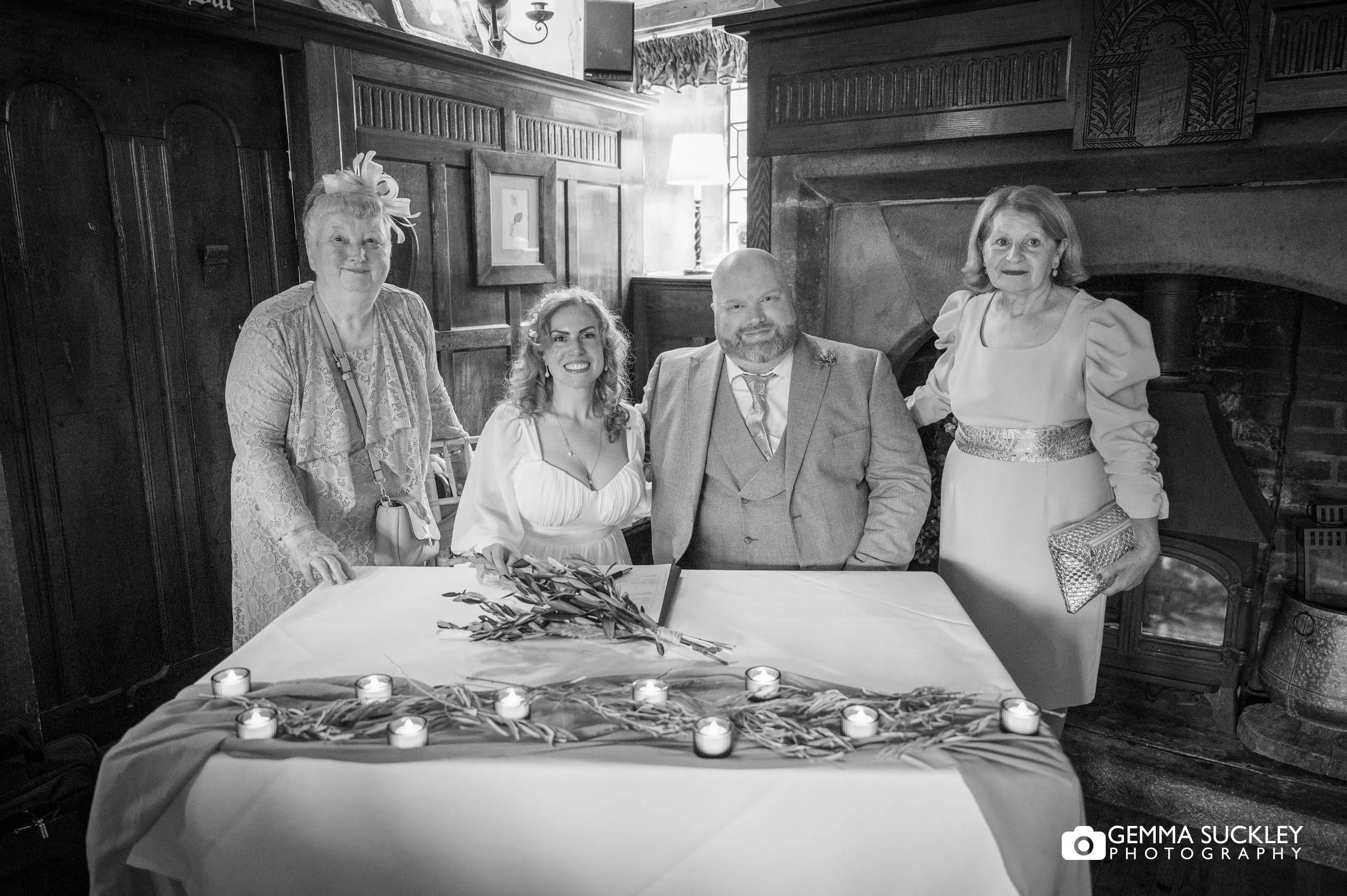 couple signing the register with witnesses