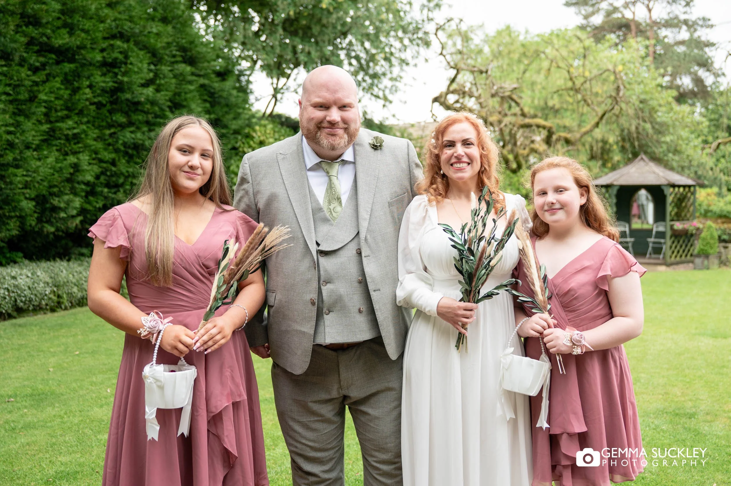 bride and groom with bridesmaids at holdsworth house wedding