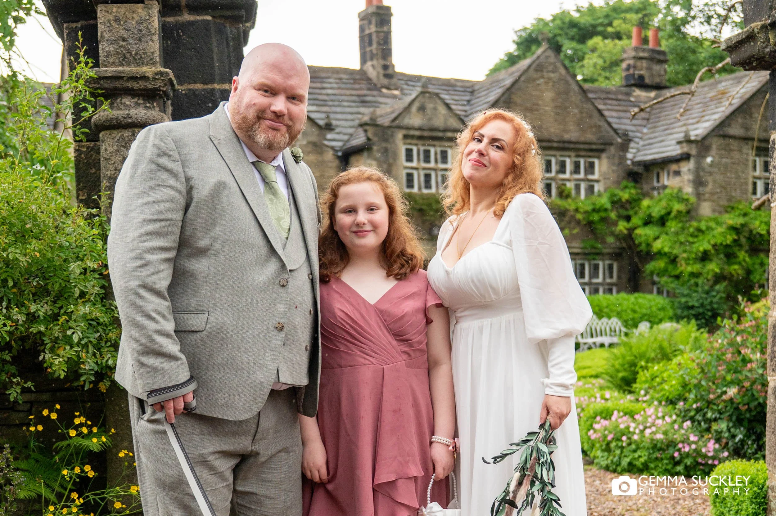 Bride and groom with their young daughter during an intimate wedding day