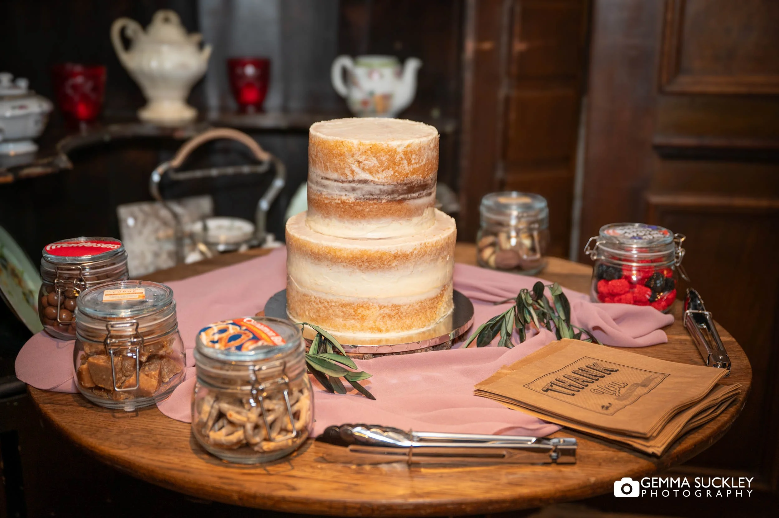 the wedding cake and sweets surrounding it