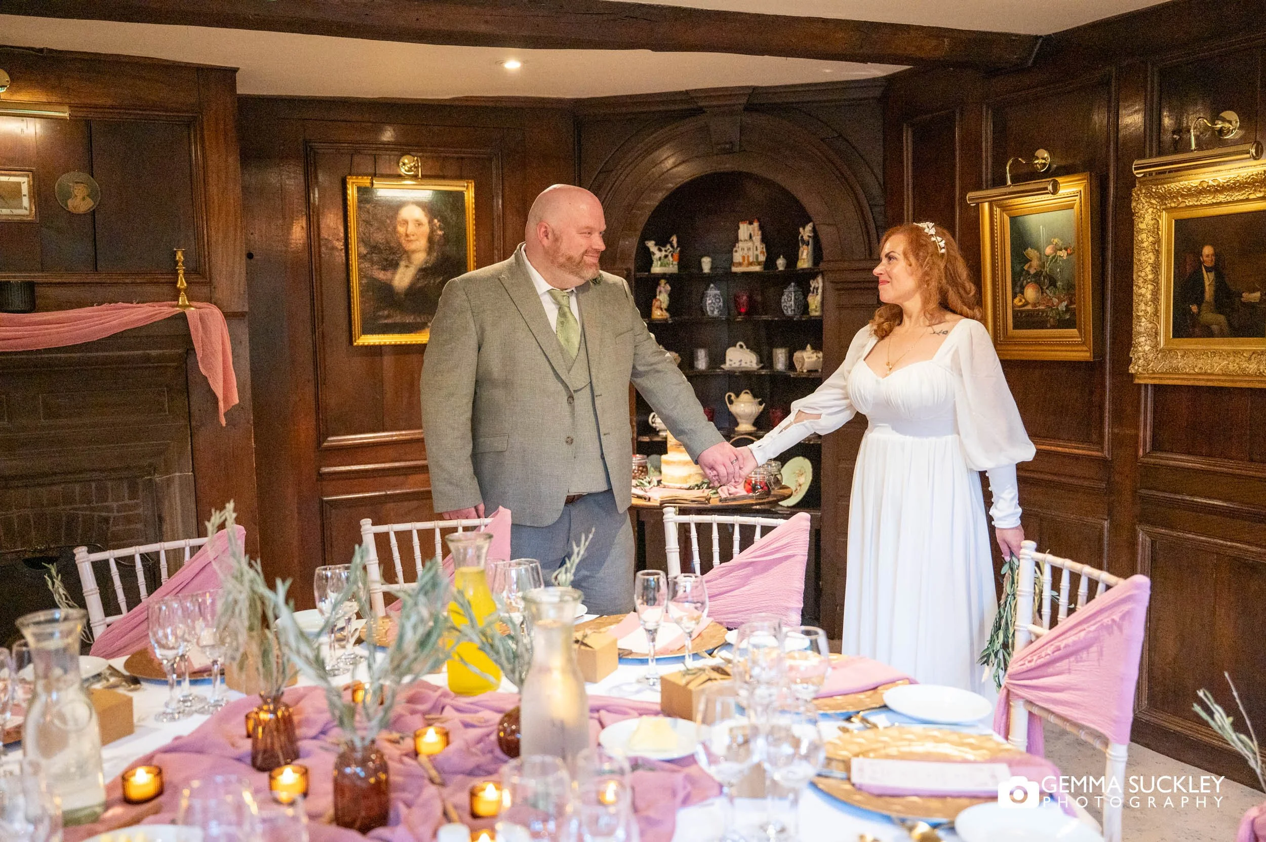 the bride and groom in front of the wedding breakfast table