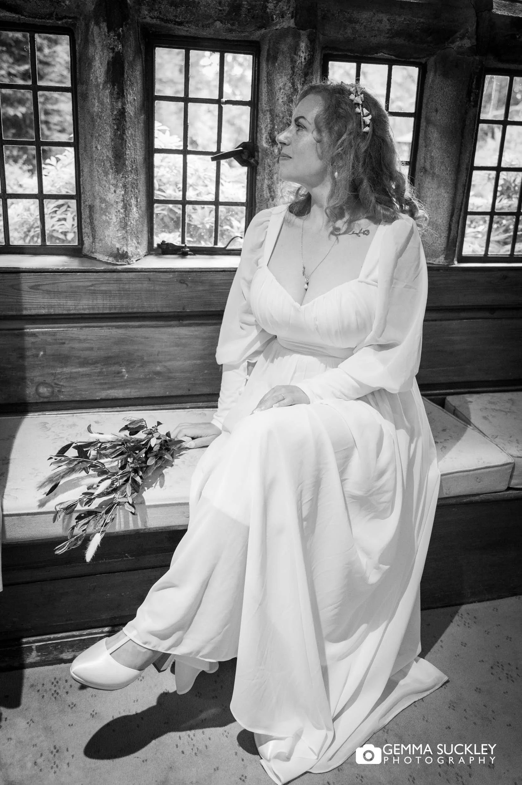 bridal portrait looking out the window at holdsworth house