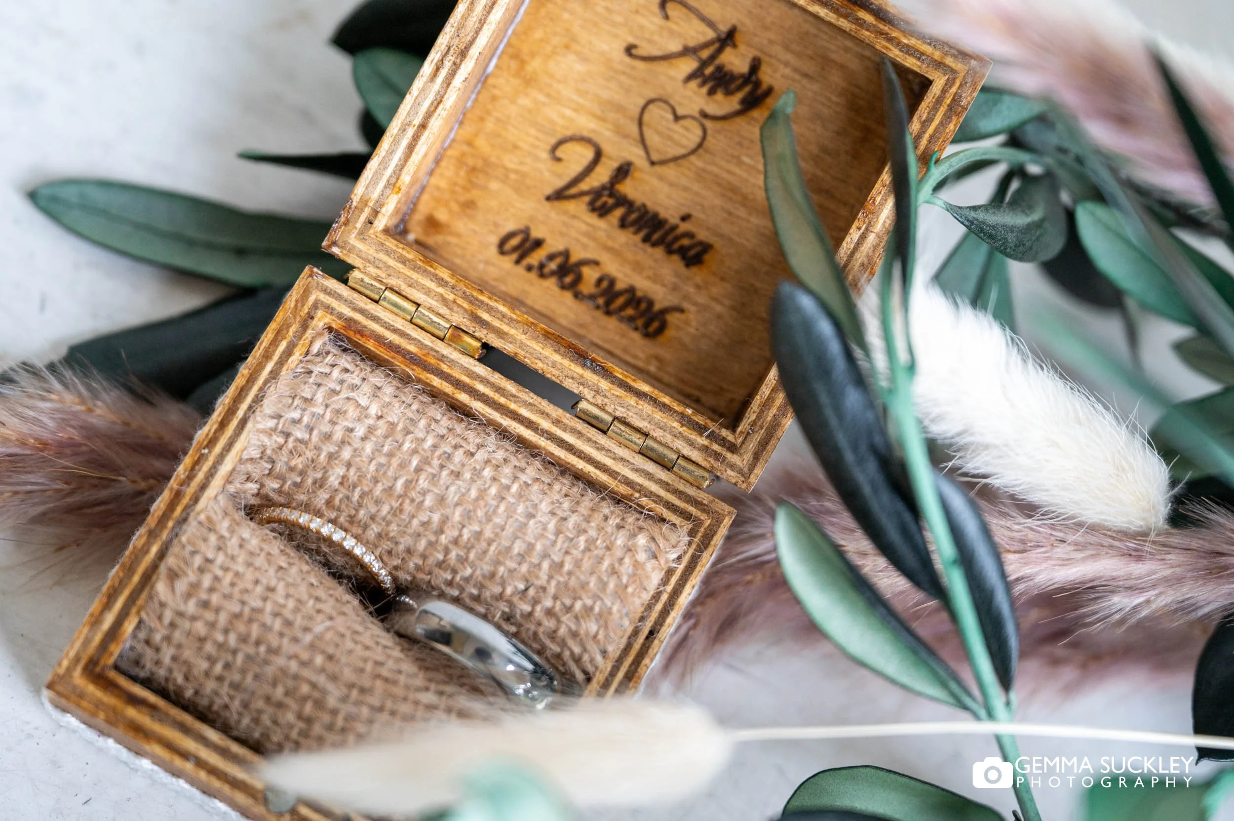 the wedding rings in a engraved box