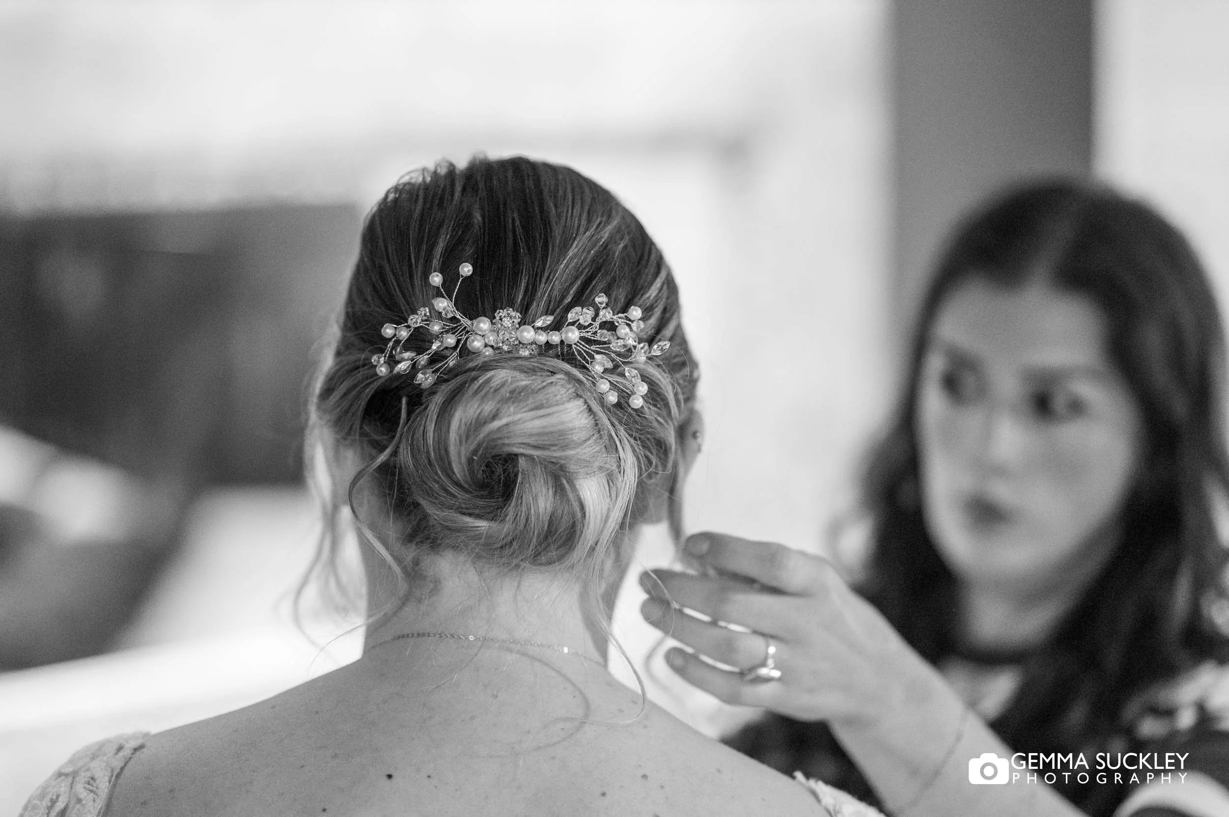 Bride having her hair done before the ceremony
