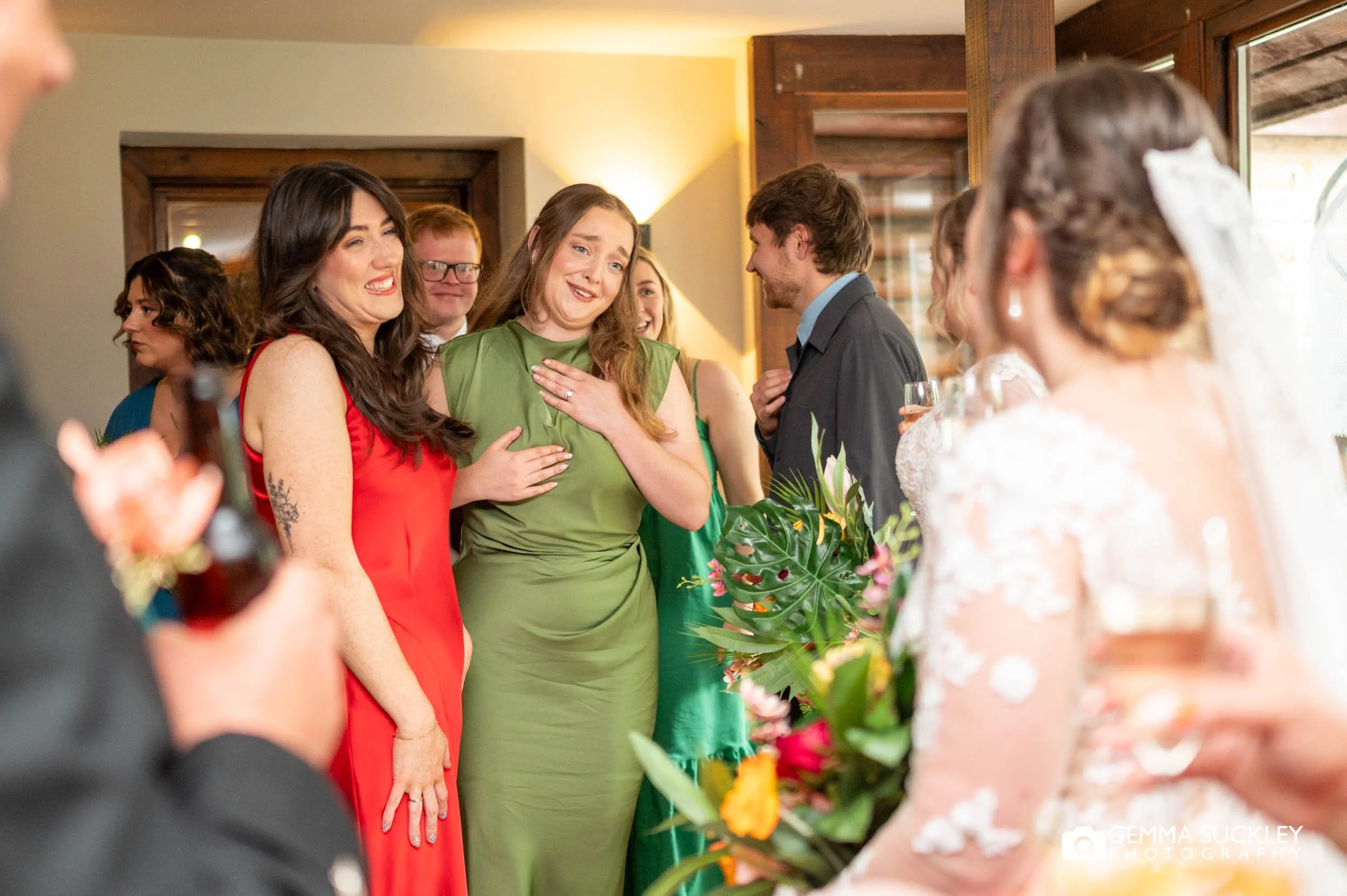 wedding guests congratulating brides