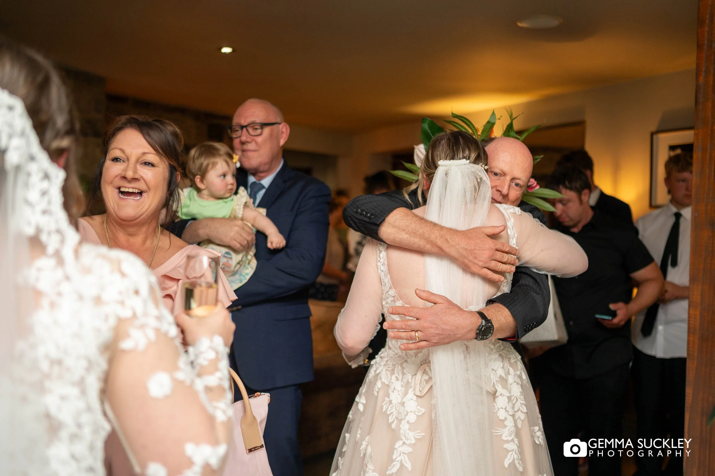 brides hugging their wedding guests