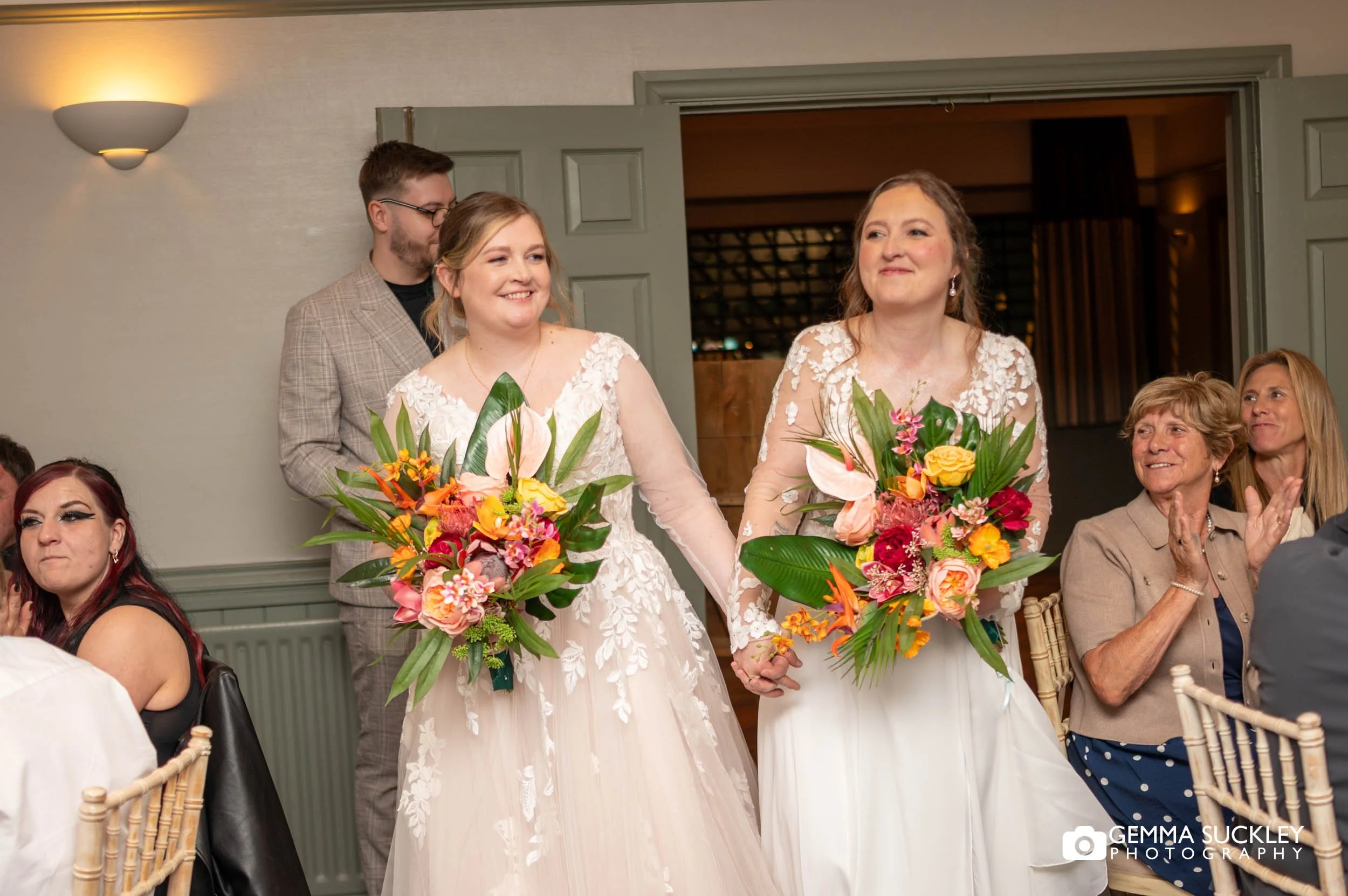 newly-weds entering the wedding breakfast room