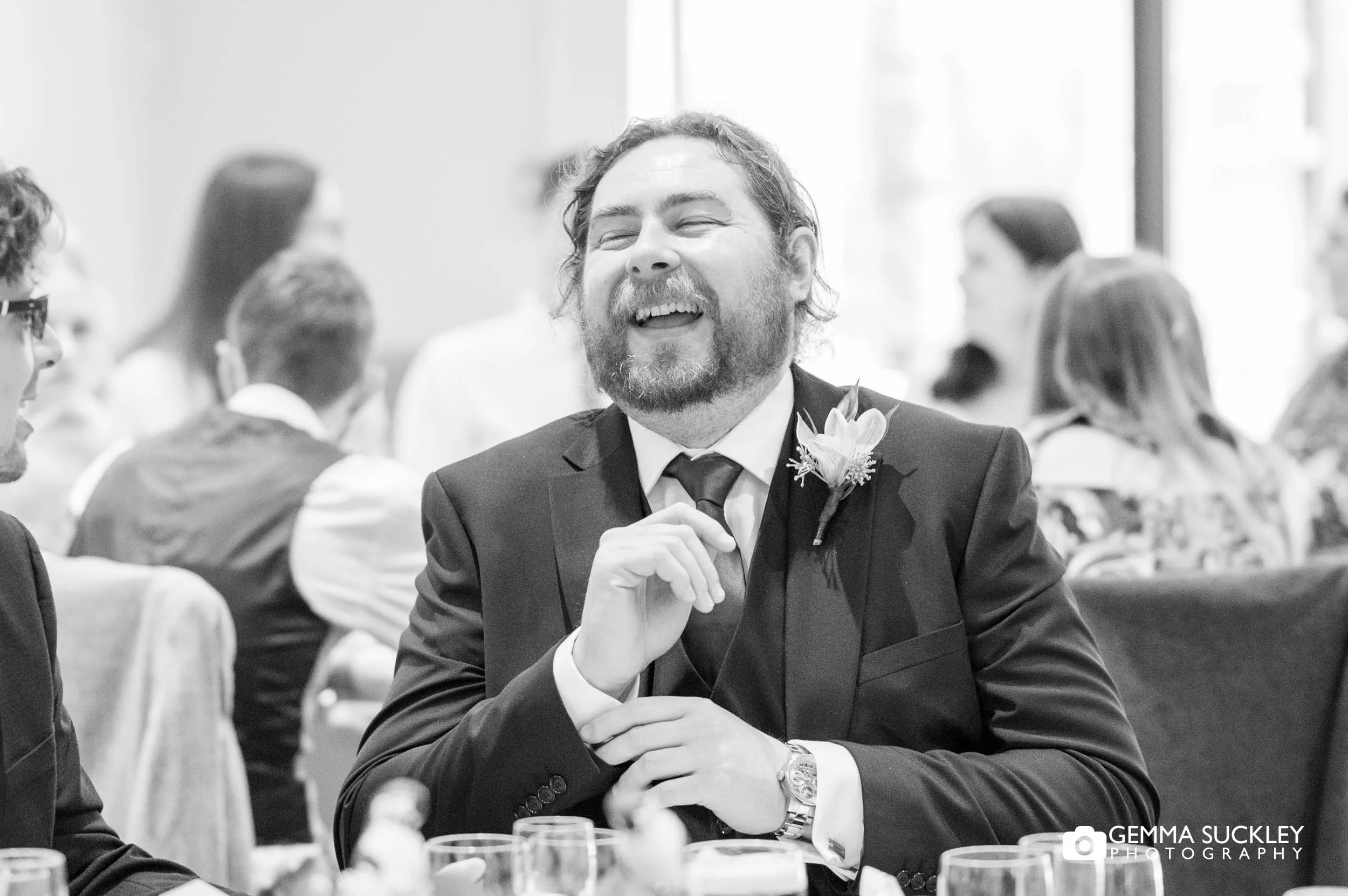guests laughing at wedding speeches