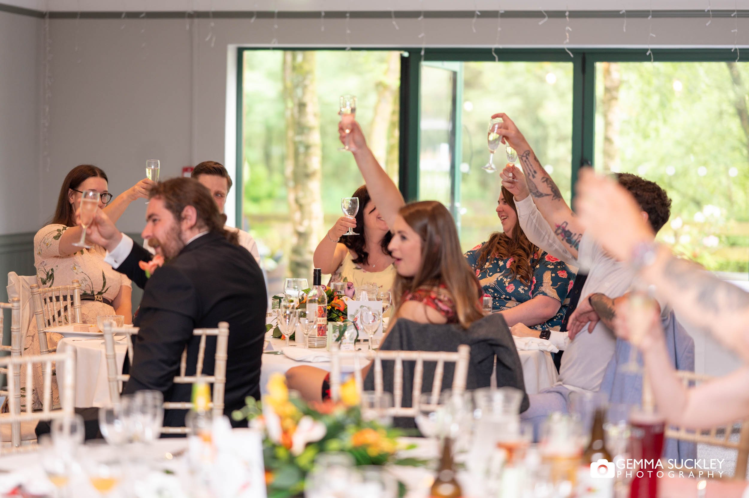 Guests raising a toast to the newlyweds