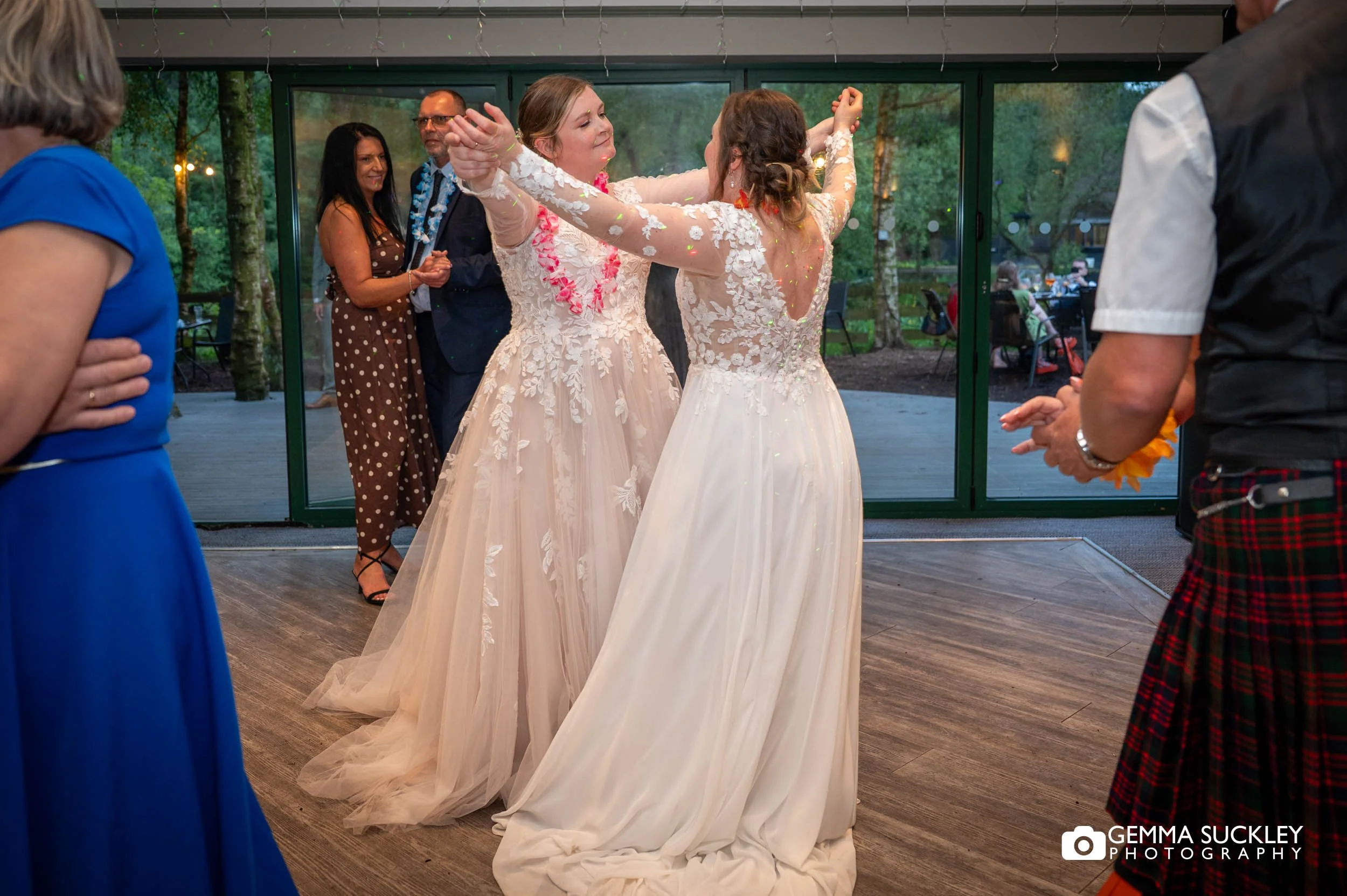 Rachel and Dagmara dancing together during their evening reception