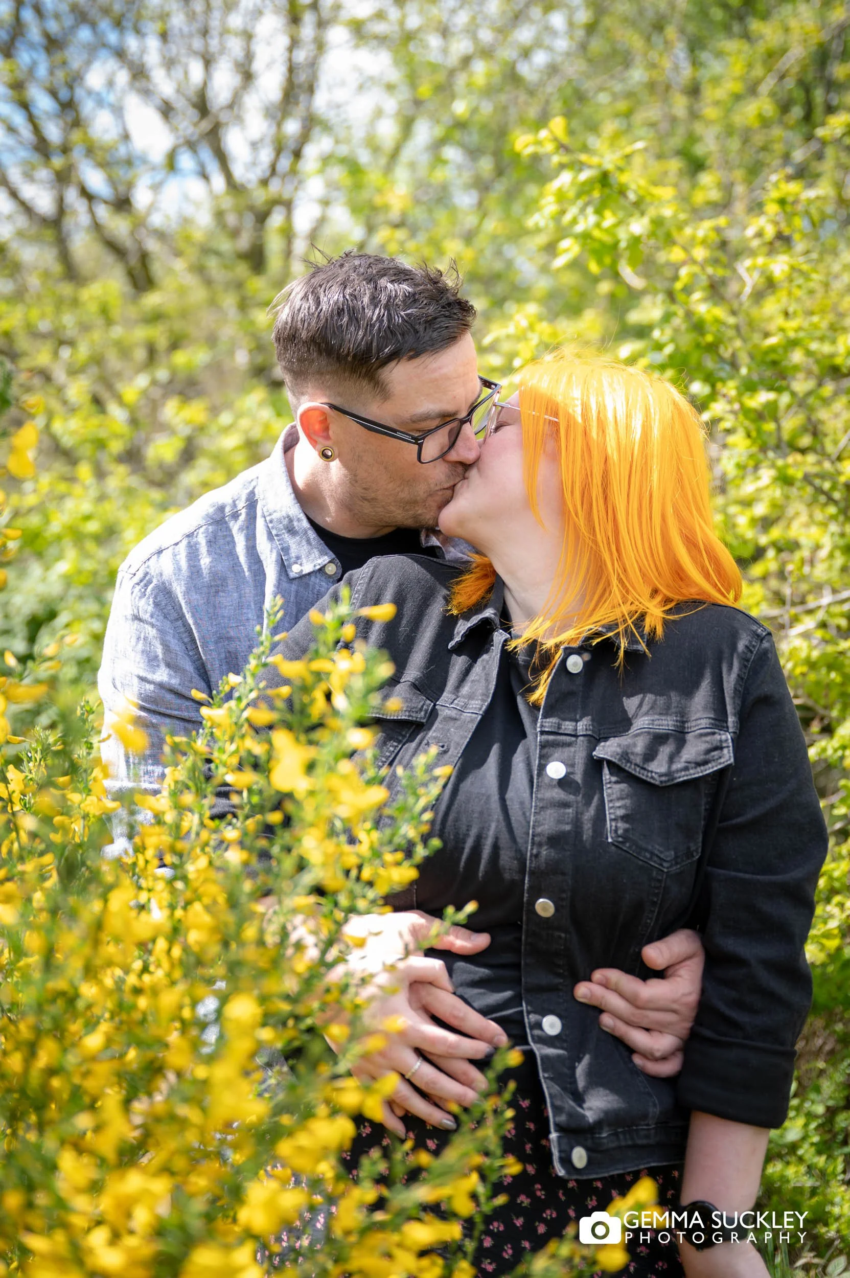 engaged alt couple sharing a kiss