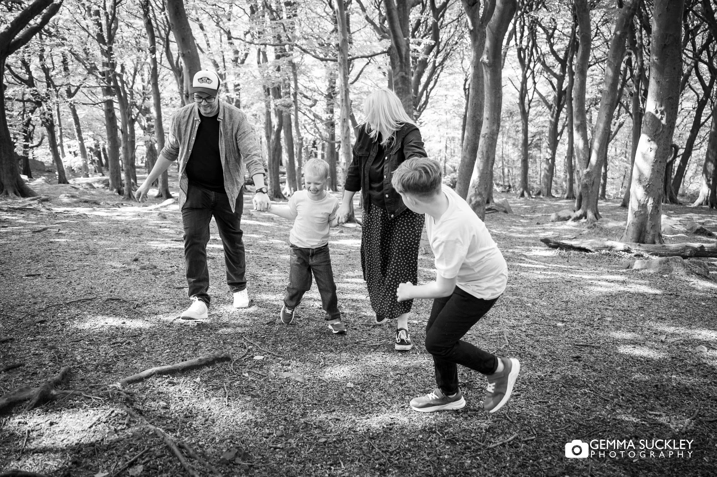 Children pulling their parents along a forest path