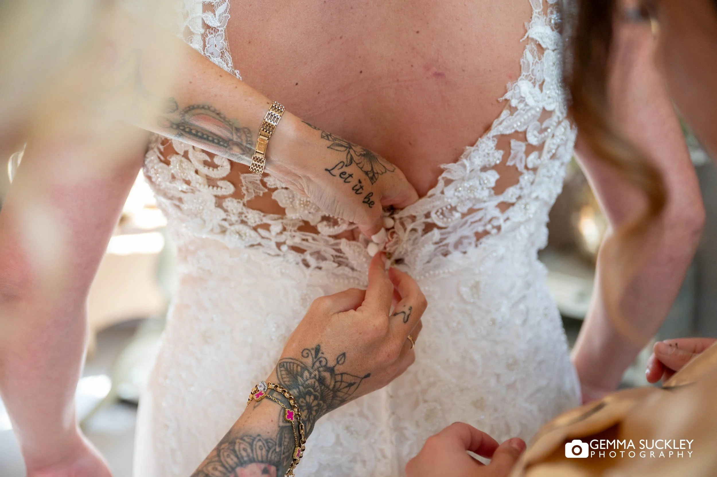 buttoning the brides dress