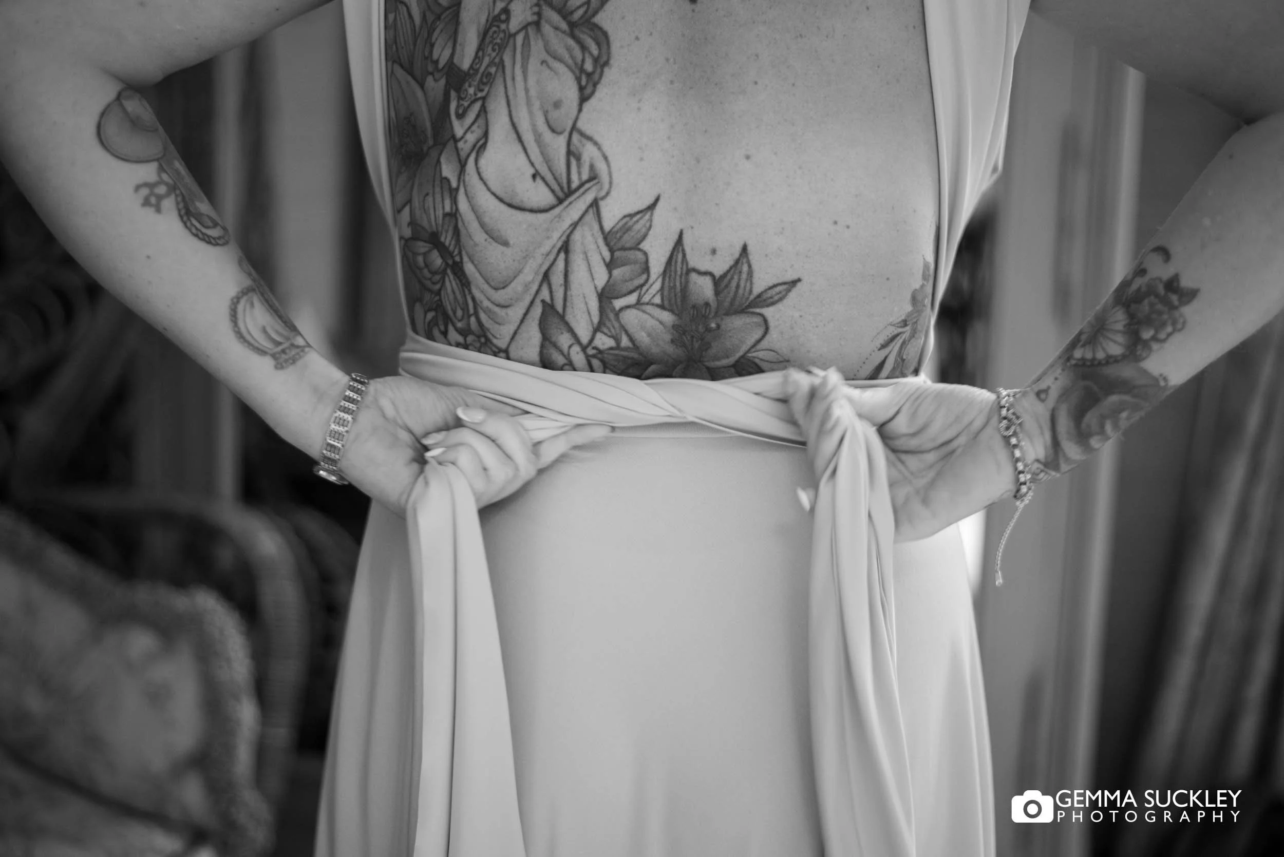 bridesmaid tying her dress