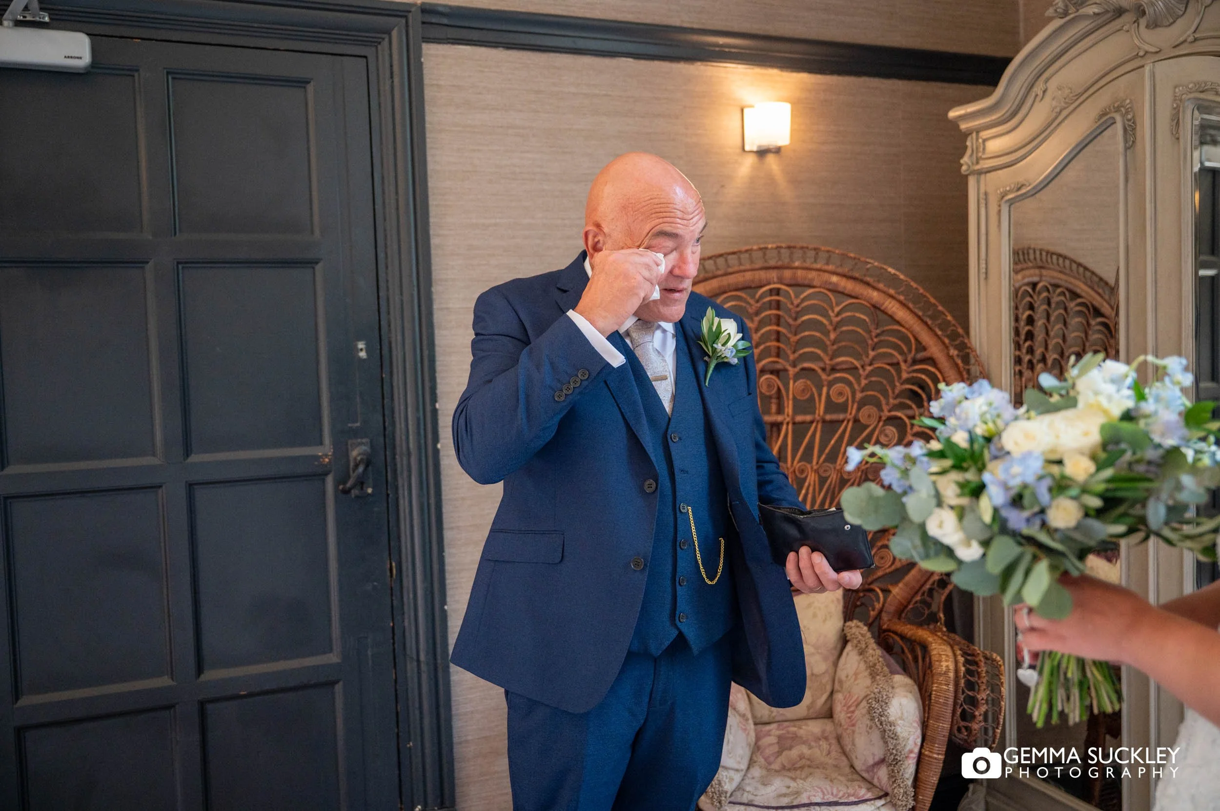 father wiping a tear at first look