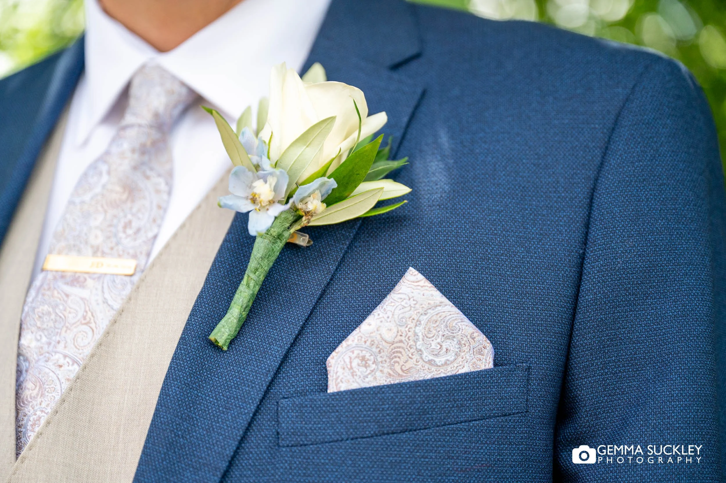 Groom wearing a buttonhole before the ceremony