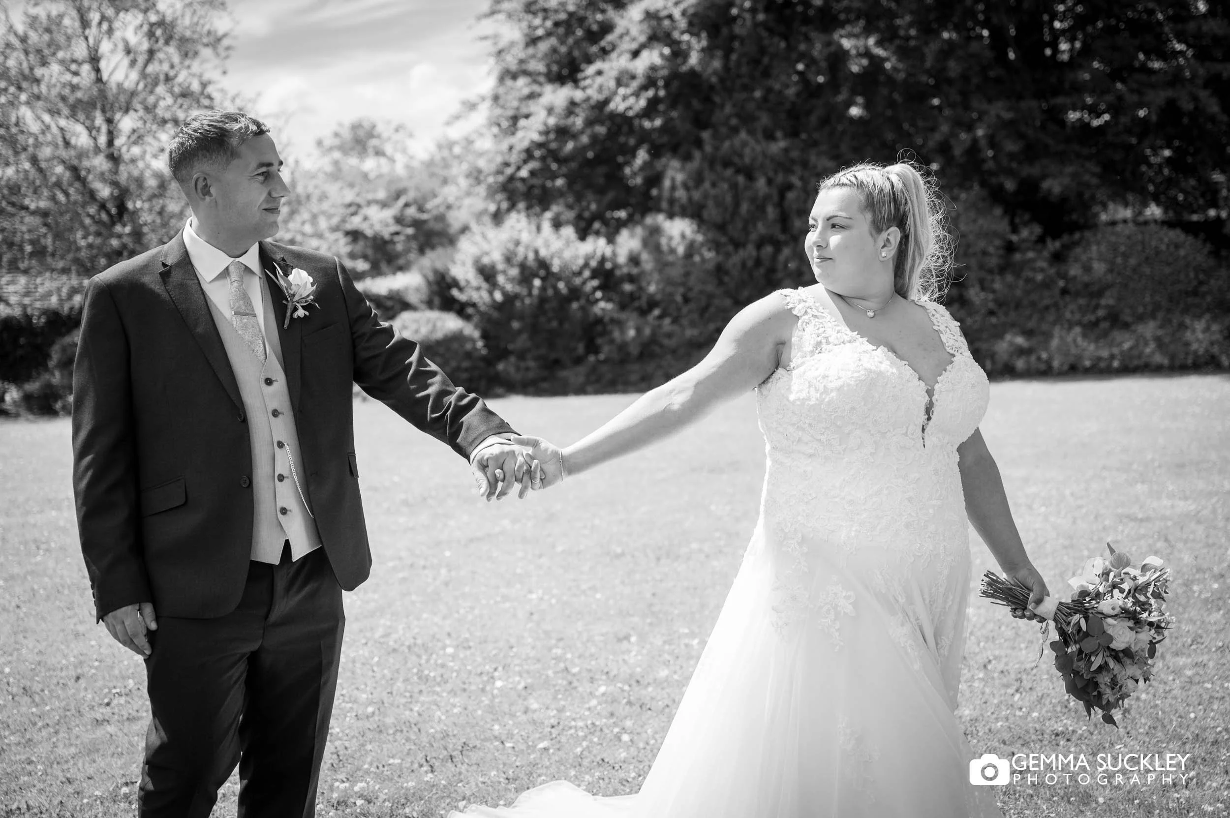 Bride and groom walking together at Falcon Manor.