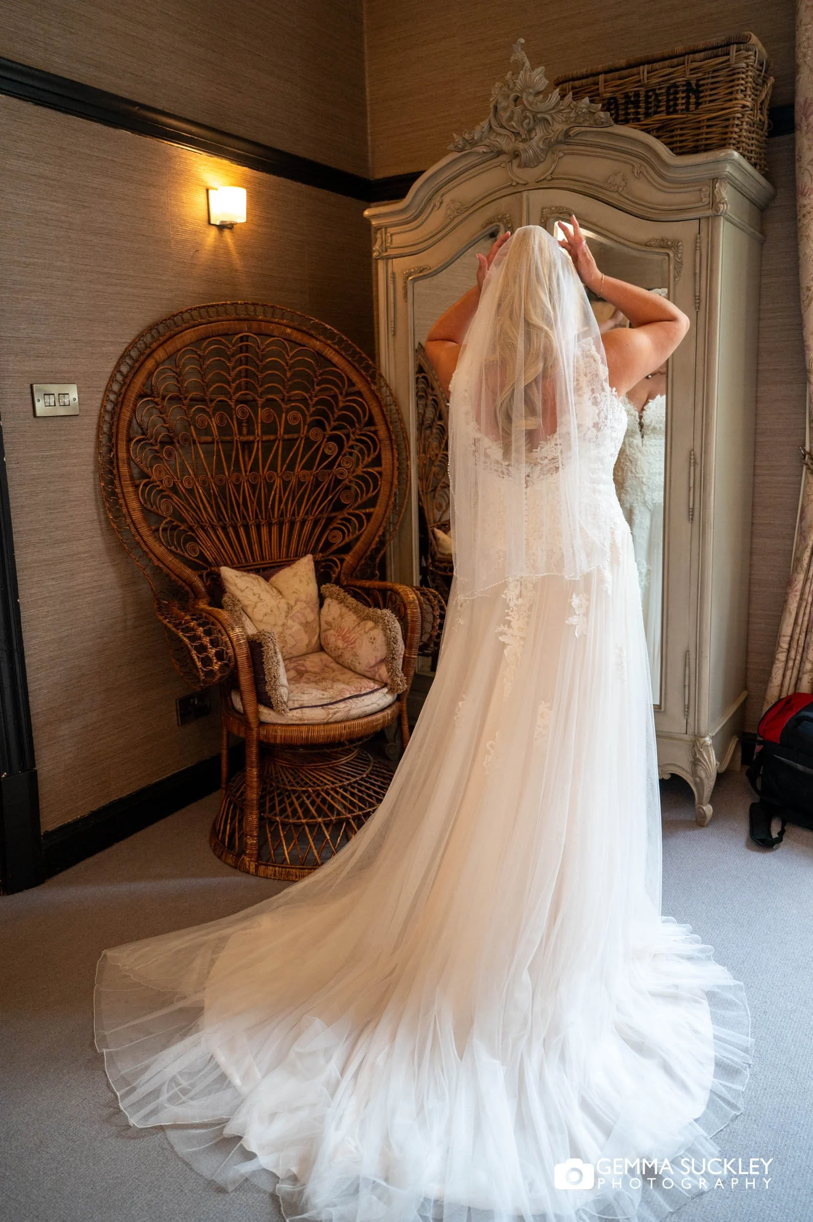 bride looking in the mirror before wedding ceremony.