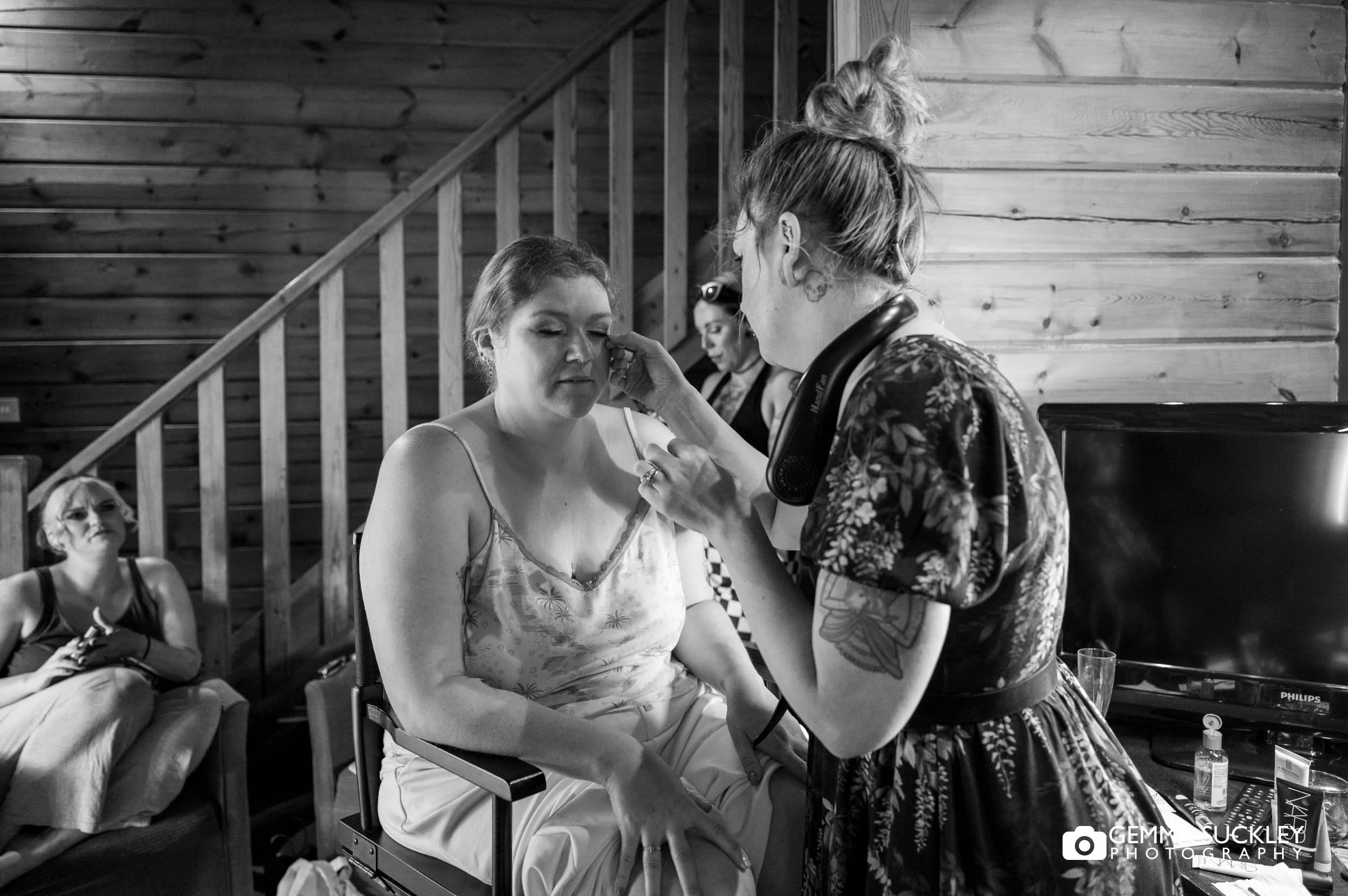 Bride having her makeup applied before the ceremony