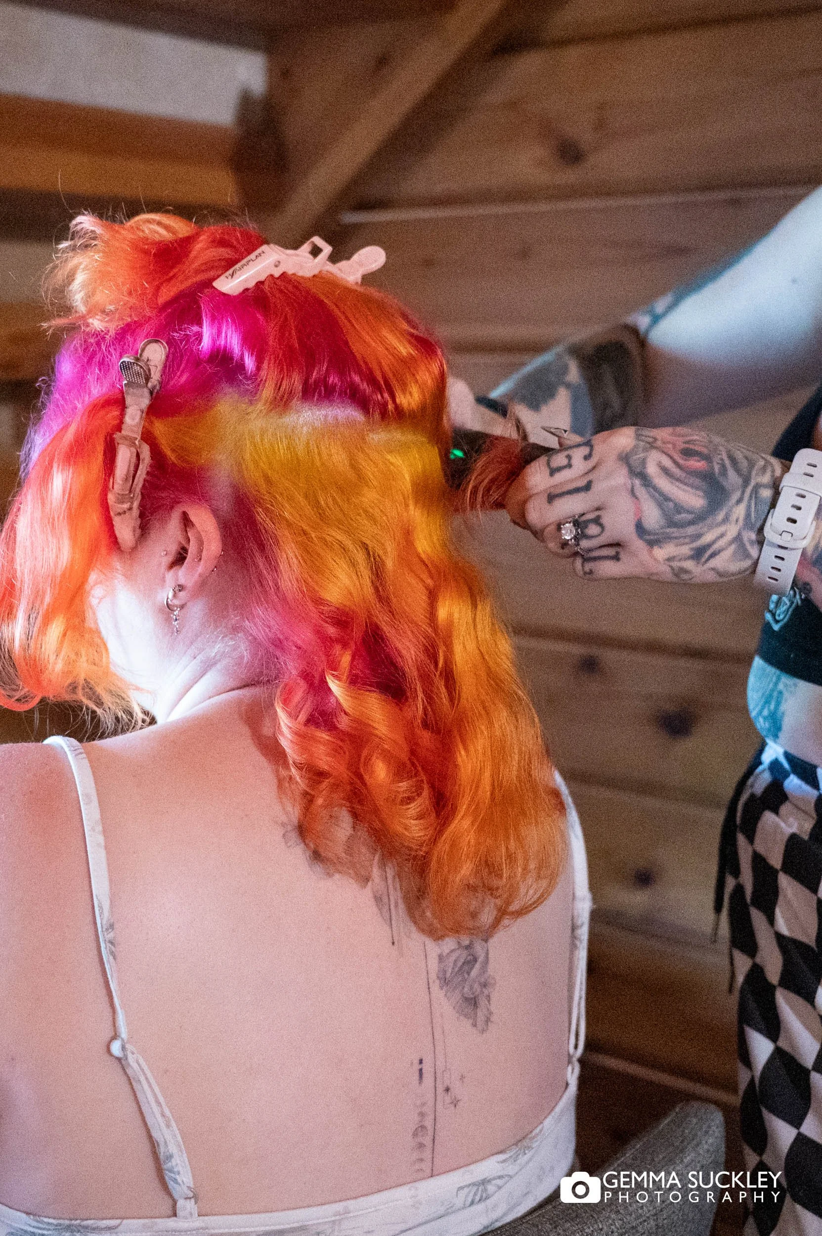 bride having her colourful hair curled