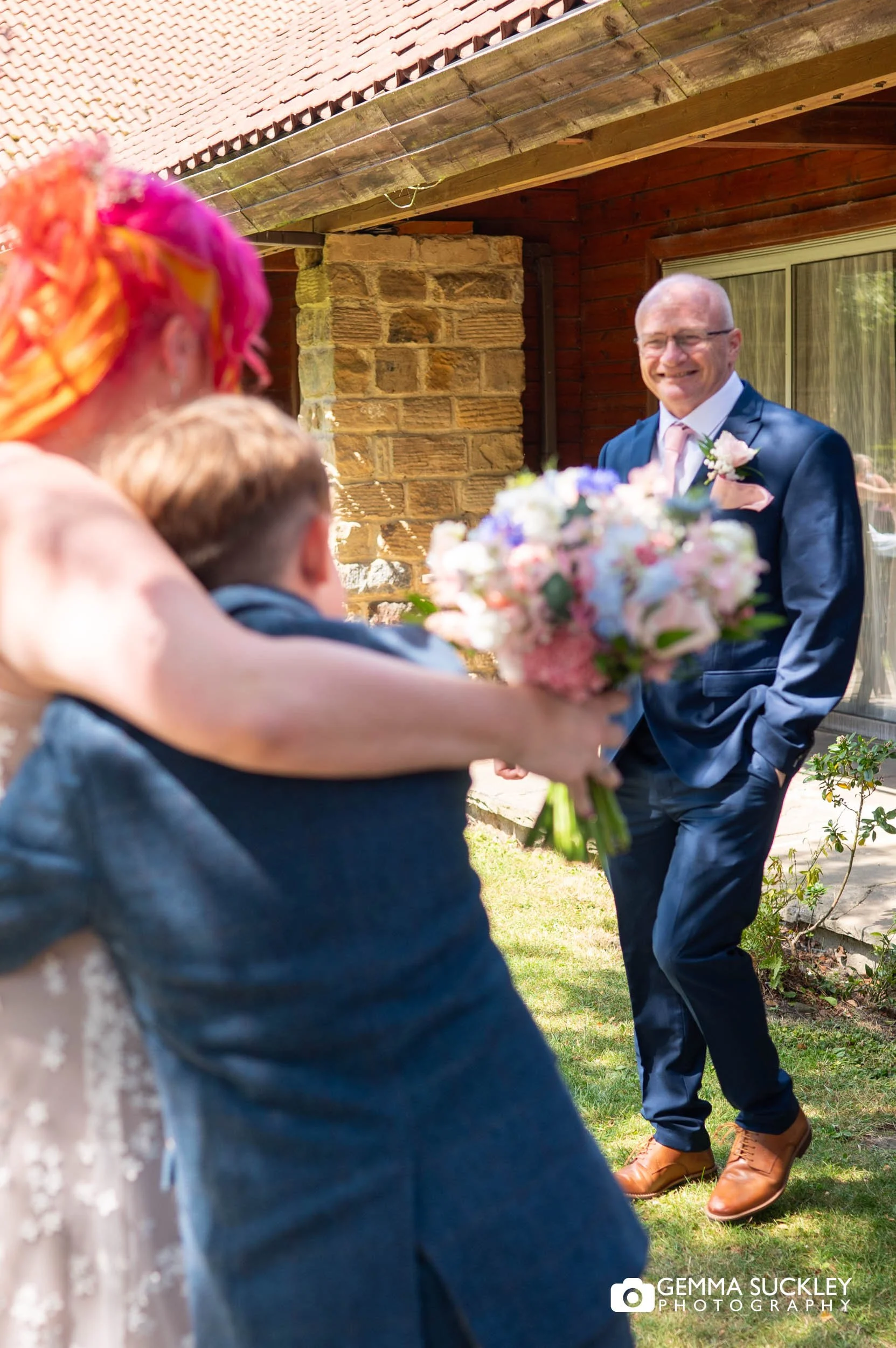 Emotional moment between the bride and her son and dad before the ceremony