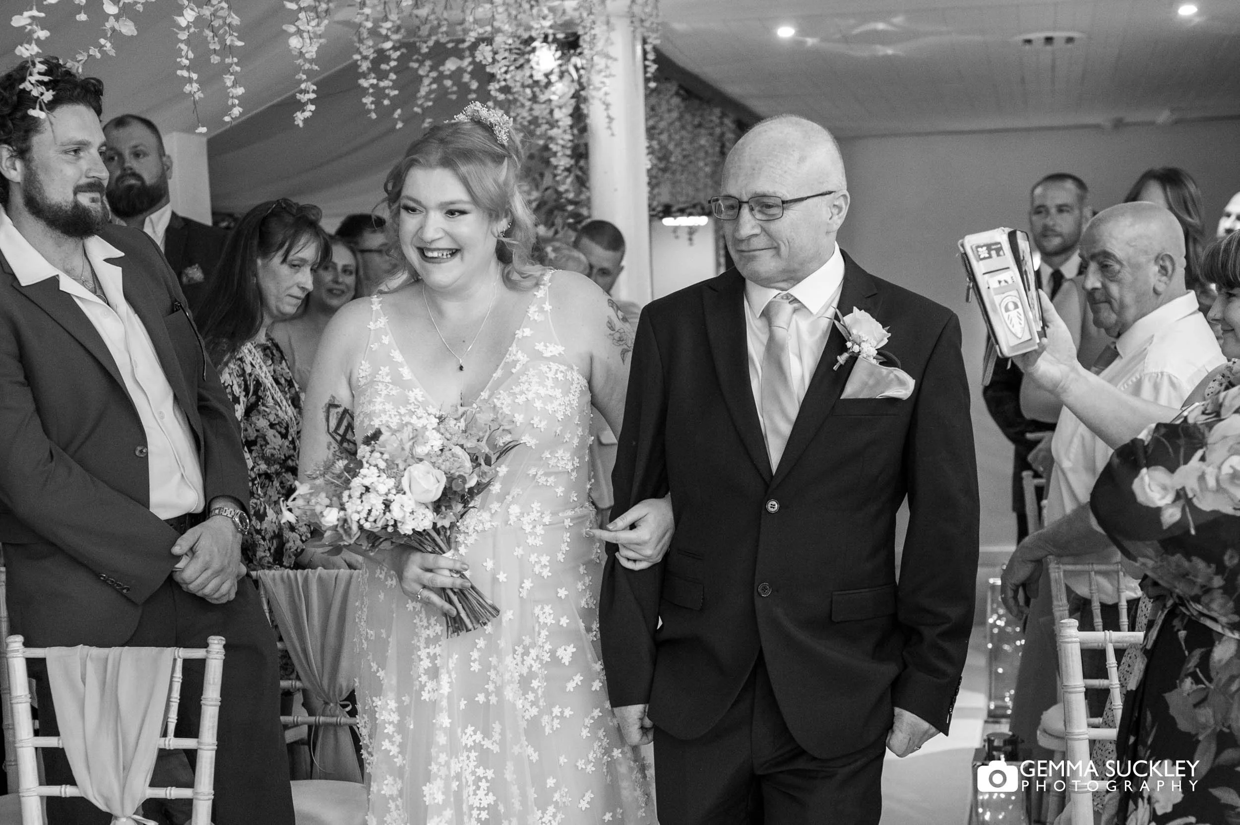 Bride walking down the aisle with her father at Chevin Country Park Hotel
