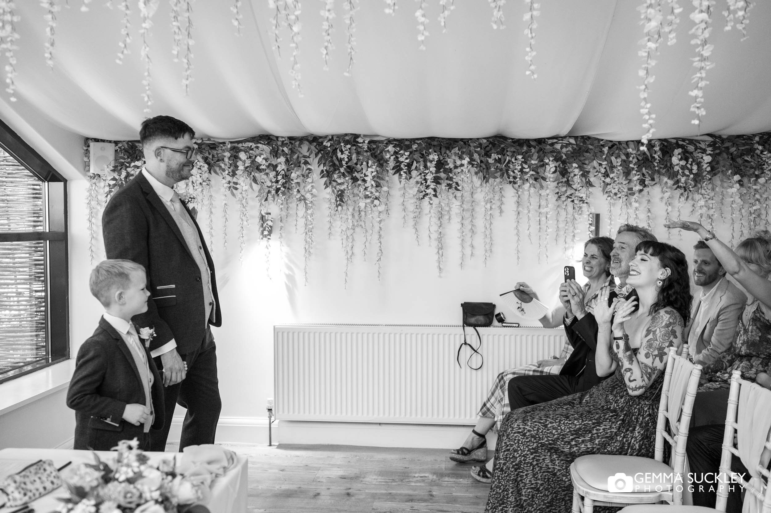 groom and son waiting at the bottom of the aisle 