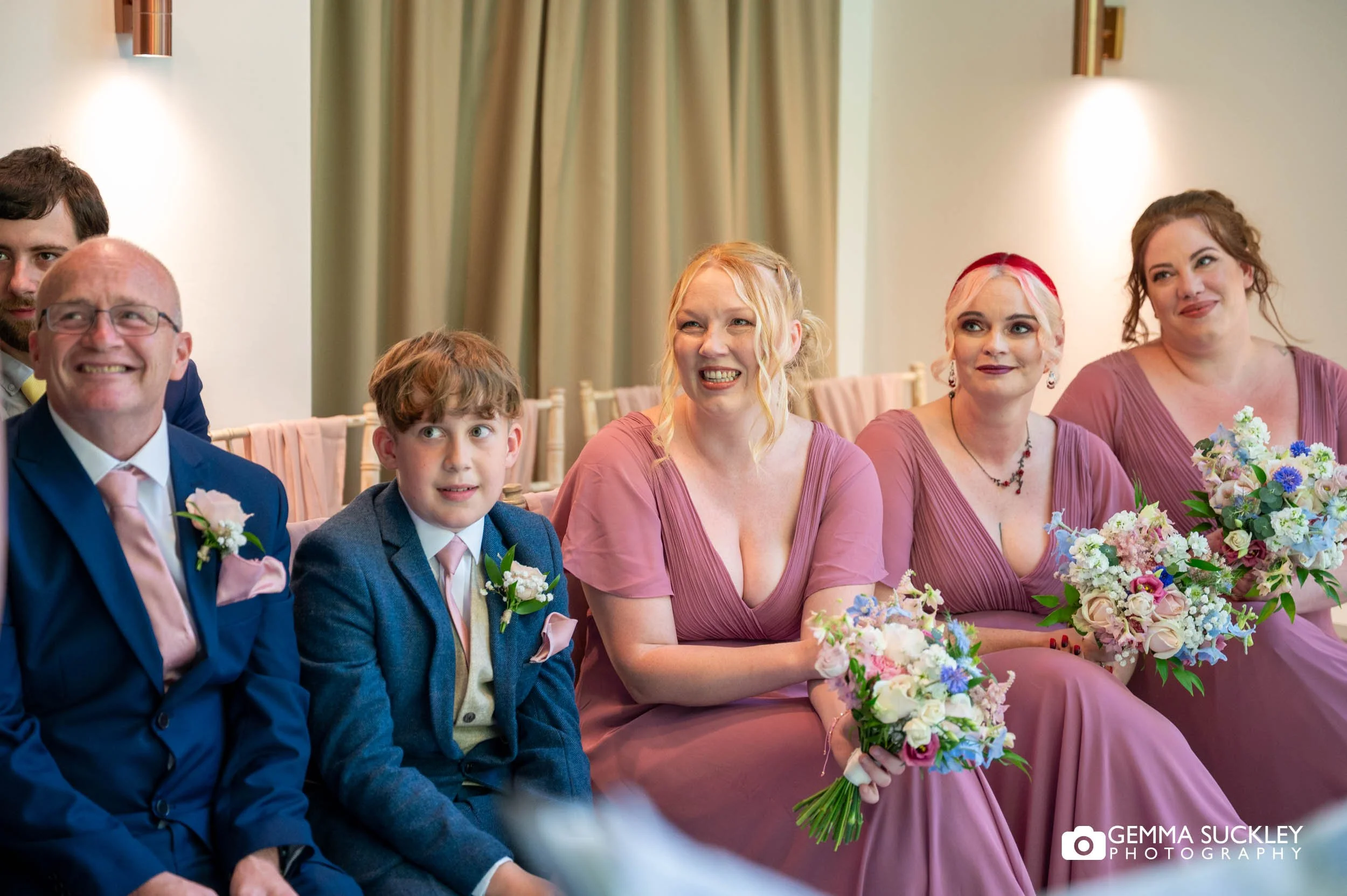 Wedding guests smiling during the ceremony