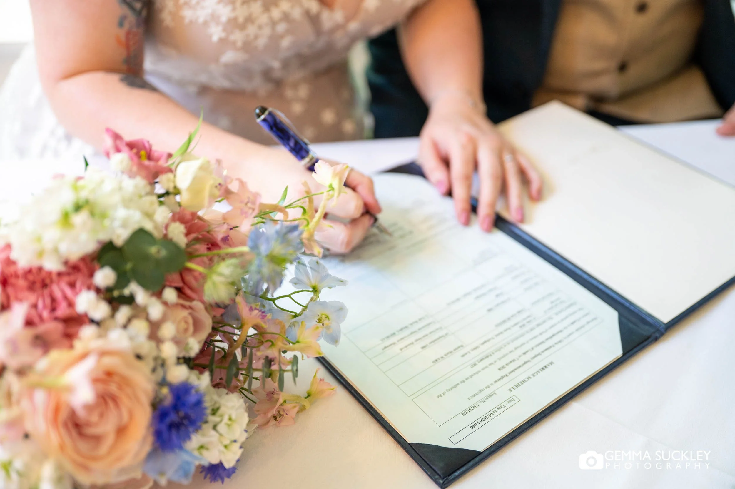 bride signing the register 