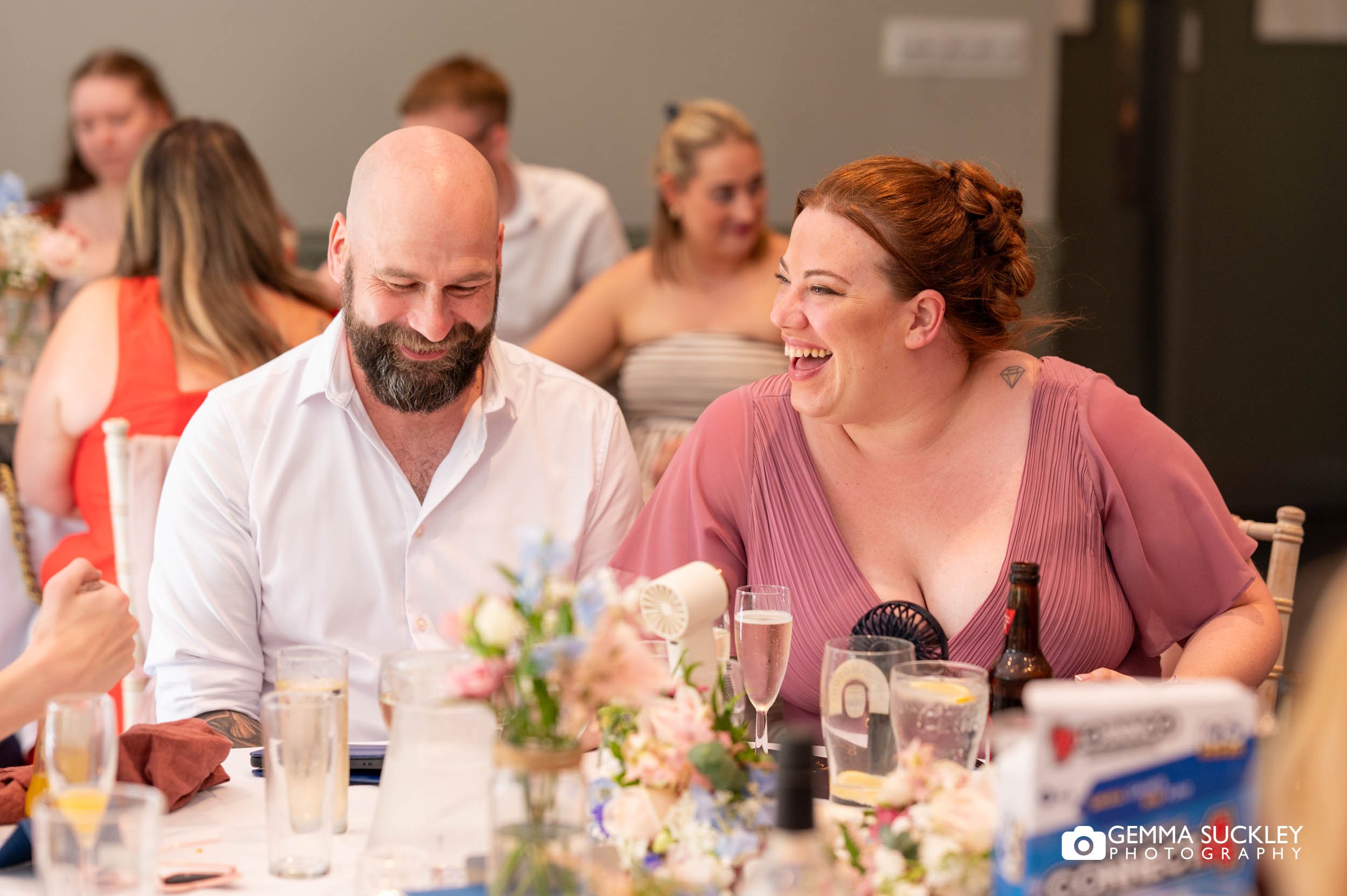 wedding guests laughing during speeches