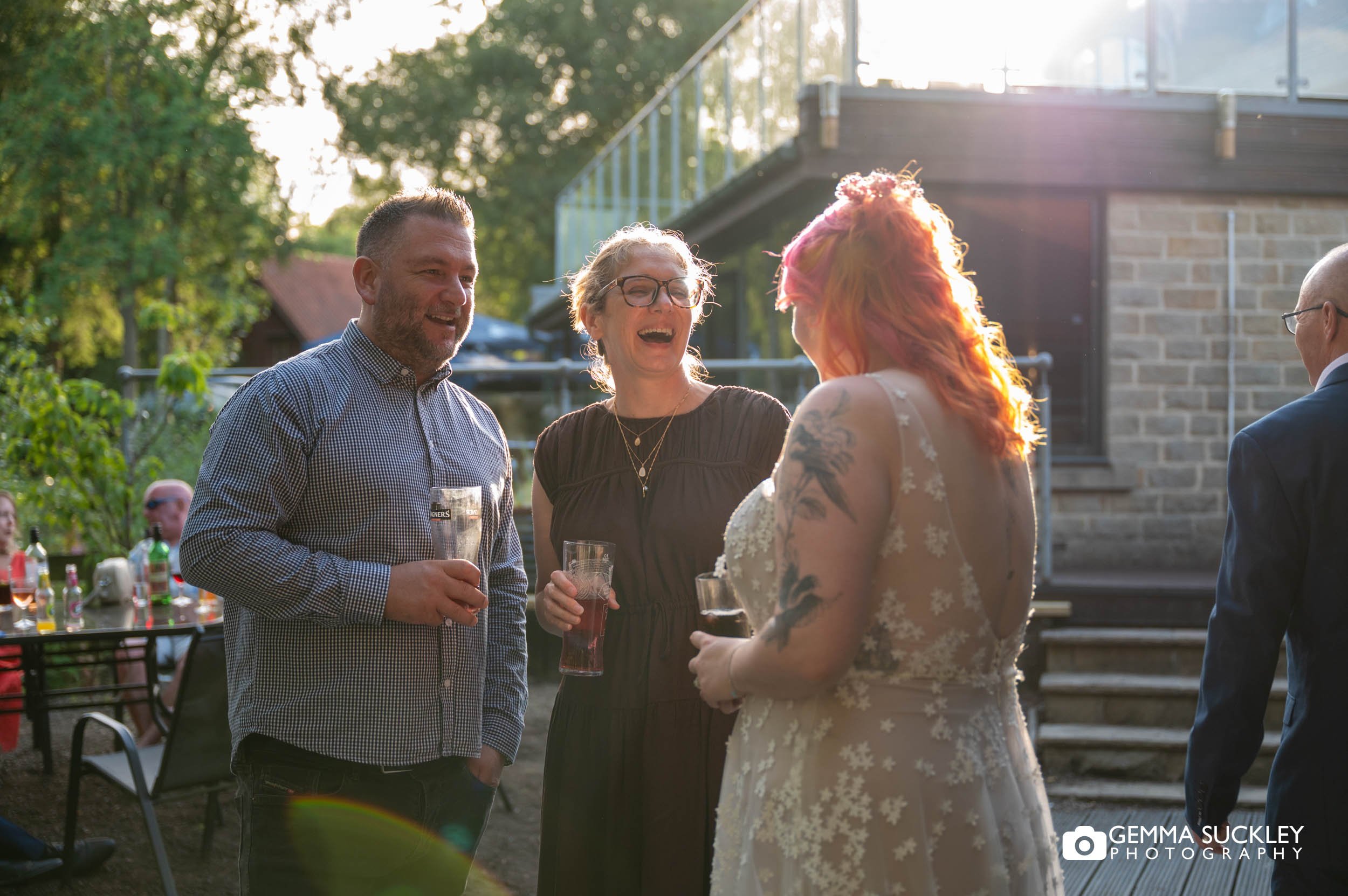 wedding guests in the evening sun
