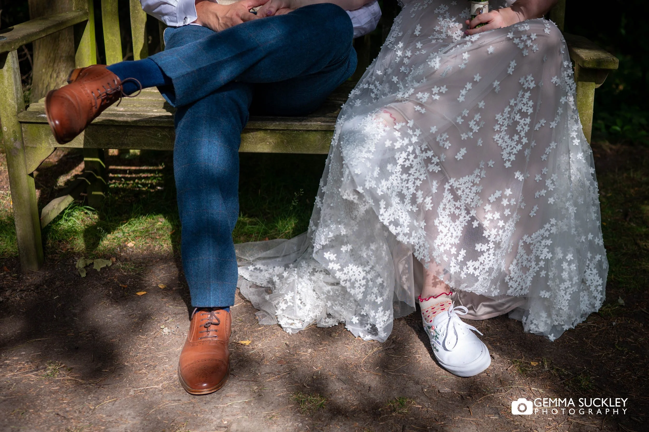 alternative bride and groom sitting in the woodland at chevin hotel