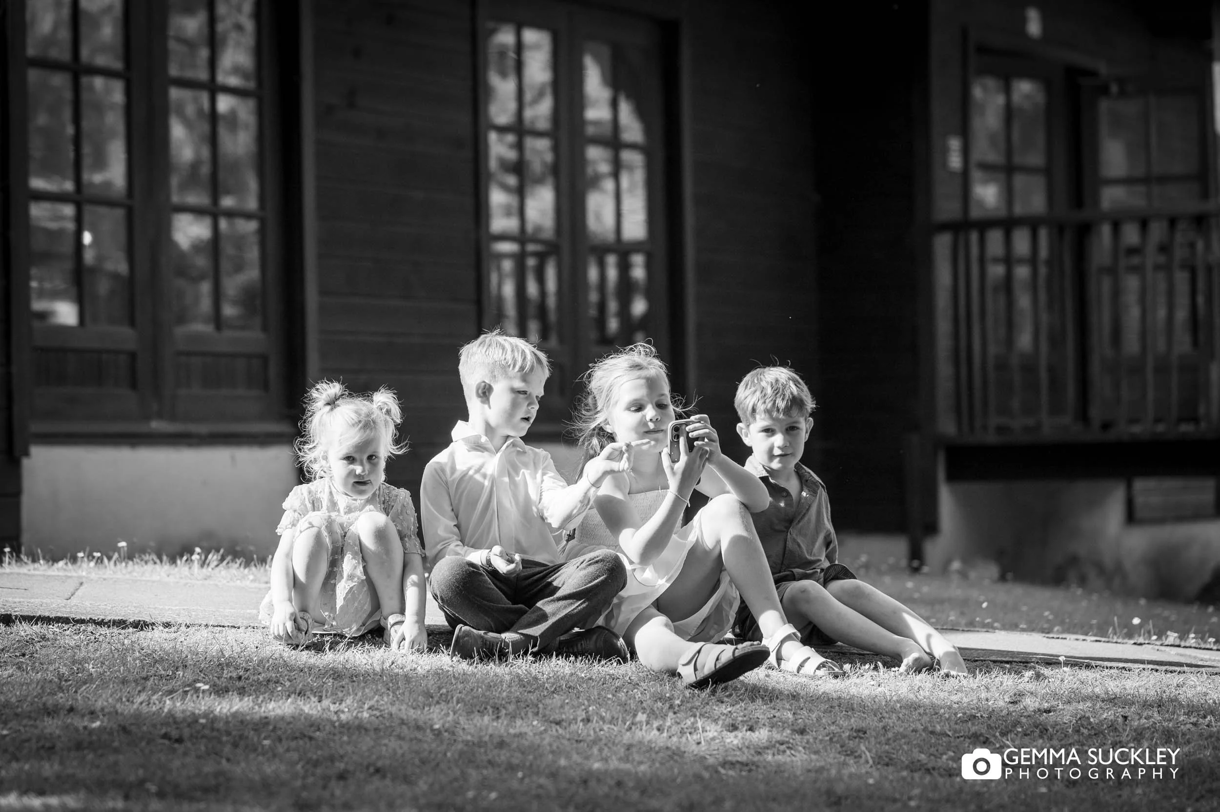 kids sitting on the lawn outside the chevin hotel