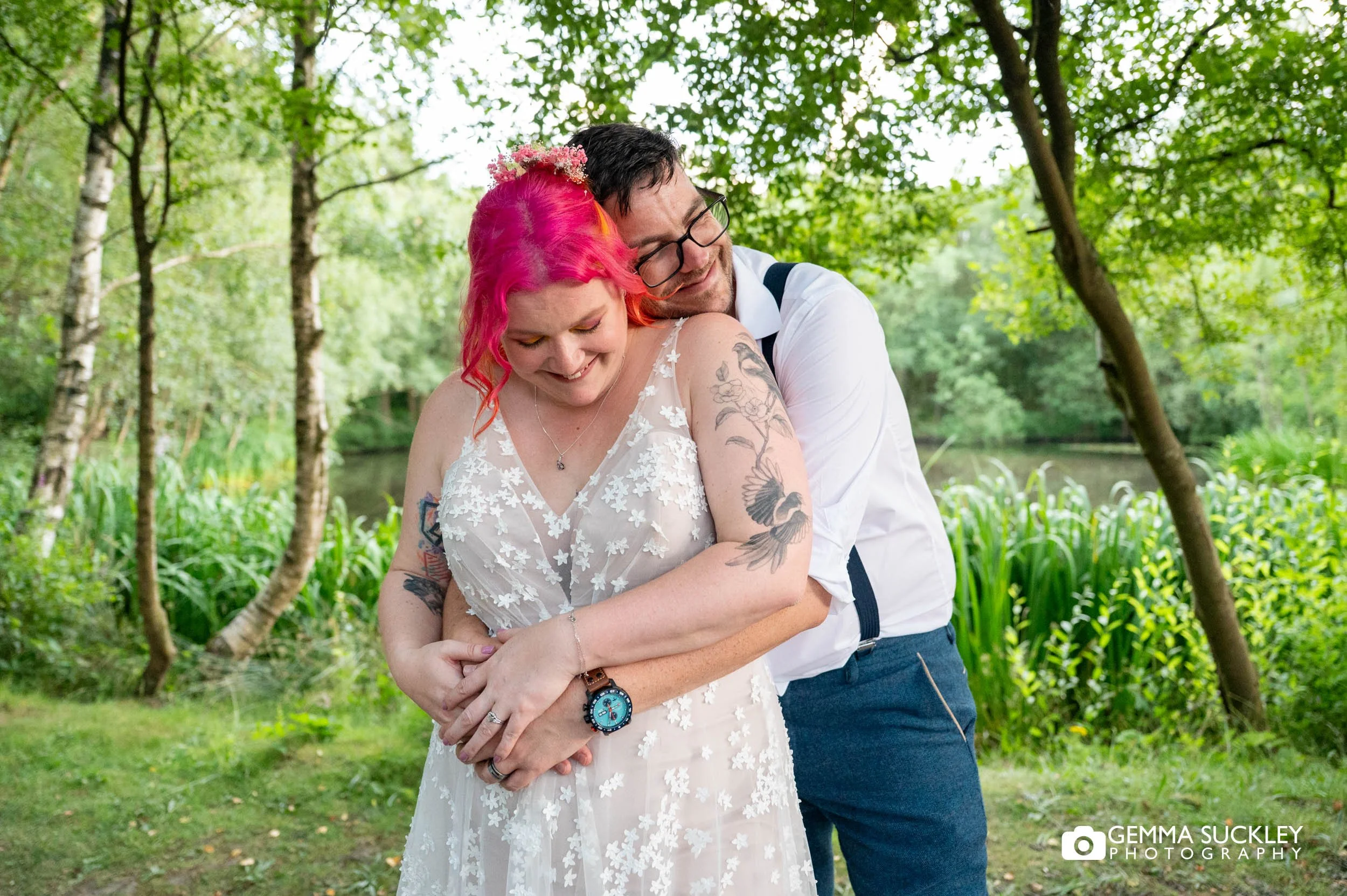 Bride and groom laughing together during relaxed wedding portraits