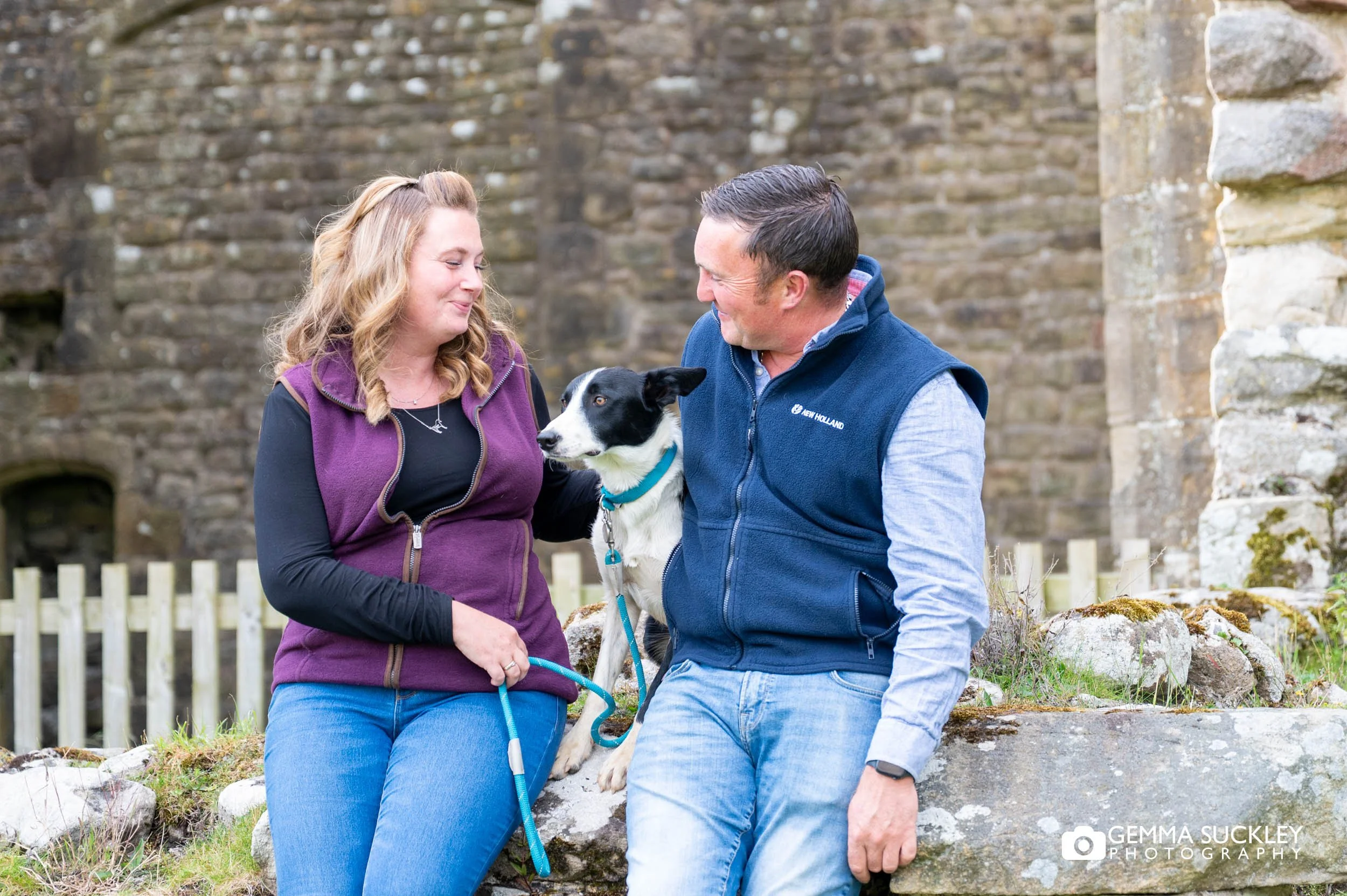 Dog sitting between the couple at barden tower