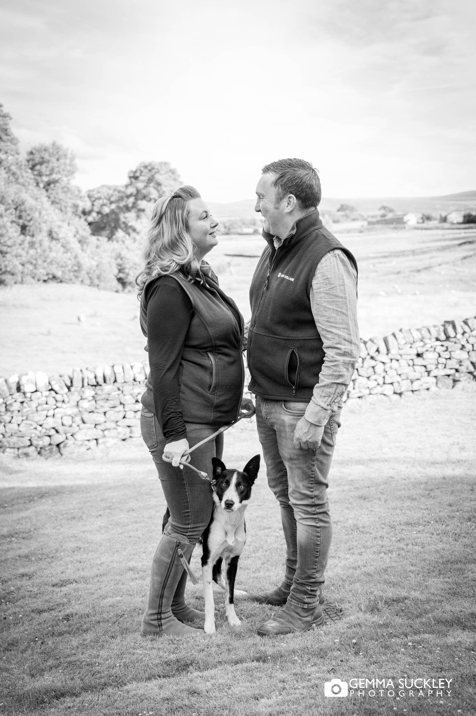 couple outside the priests house with their dog