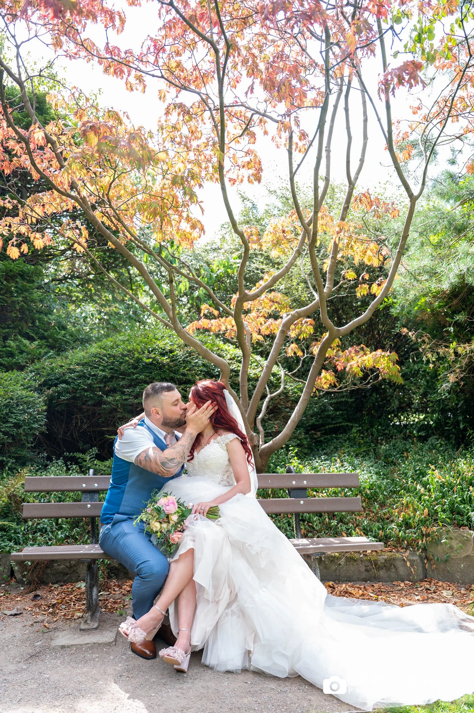 Newlyweds sitting in the Valley Gardens after their ceremony