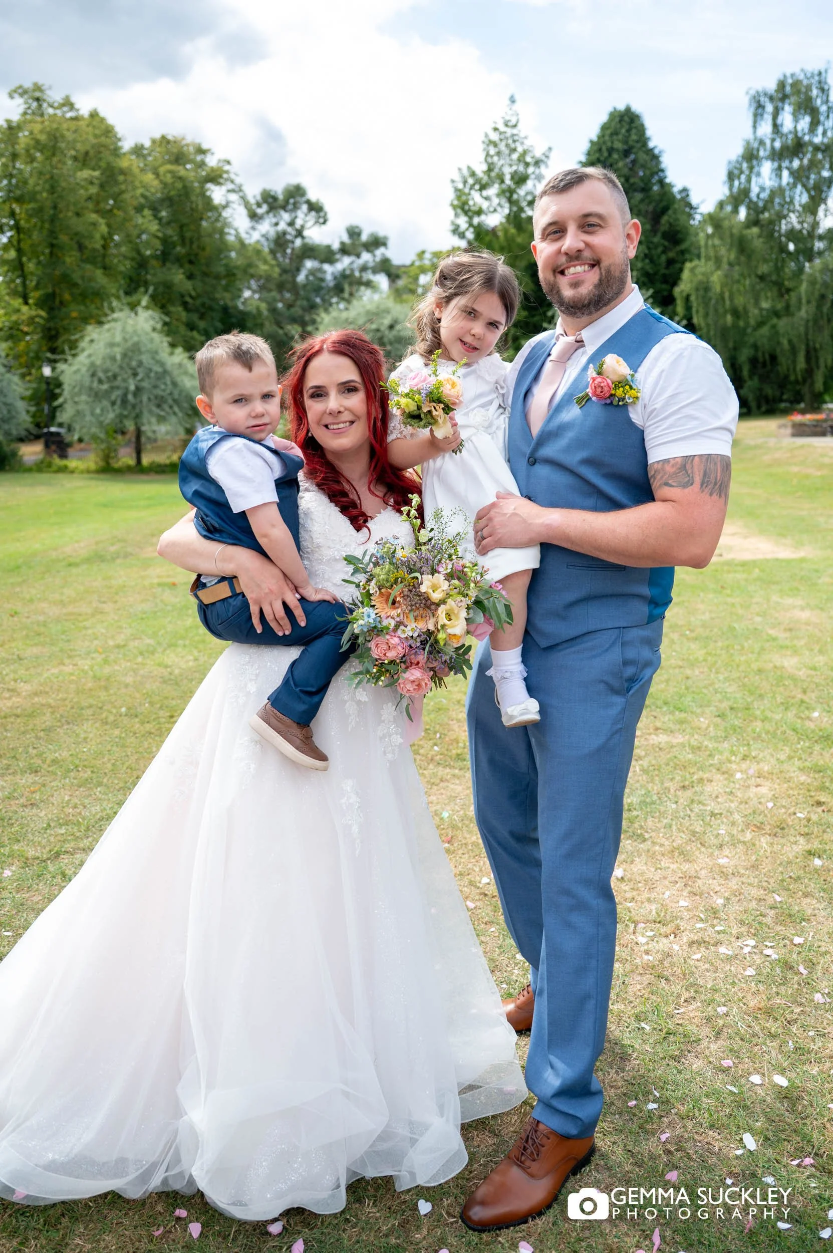 bride and groom with their children in valley gardens