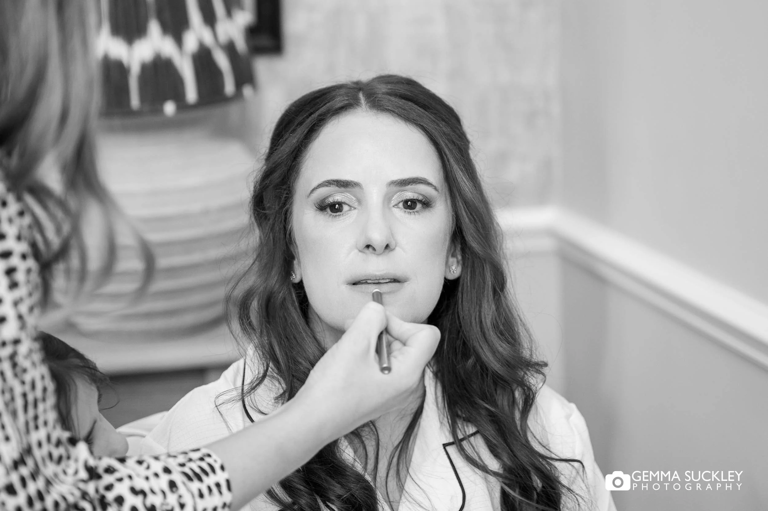 bride getting makeup done