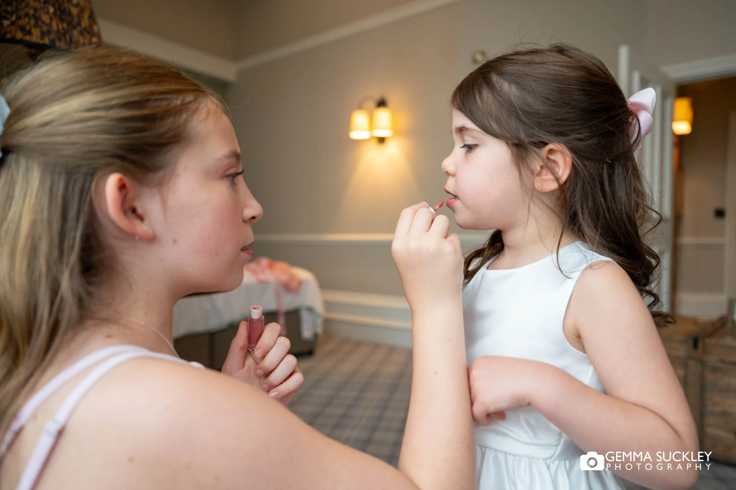 flower girl putting on lip gloss