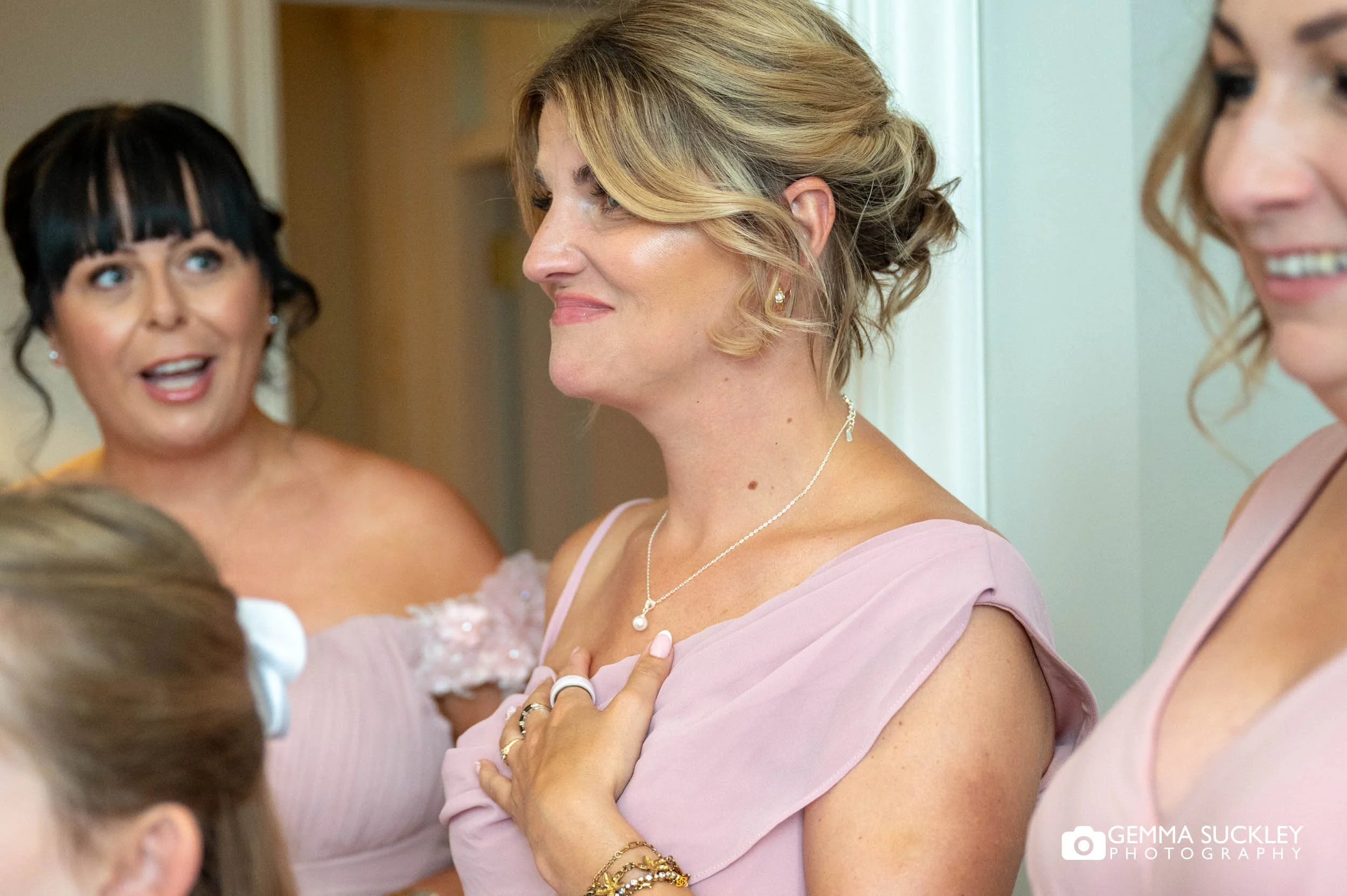 bridesmaid reacting to bride in her dress