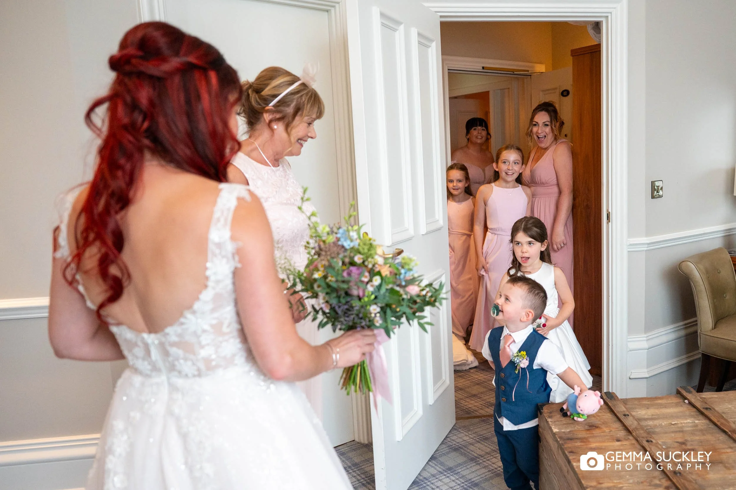 bridal party walking onto the harrogate Inn to see the bride in her dress