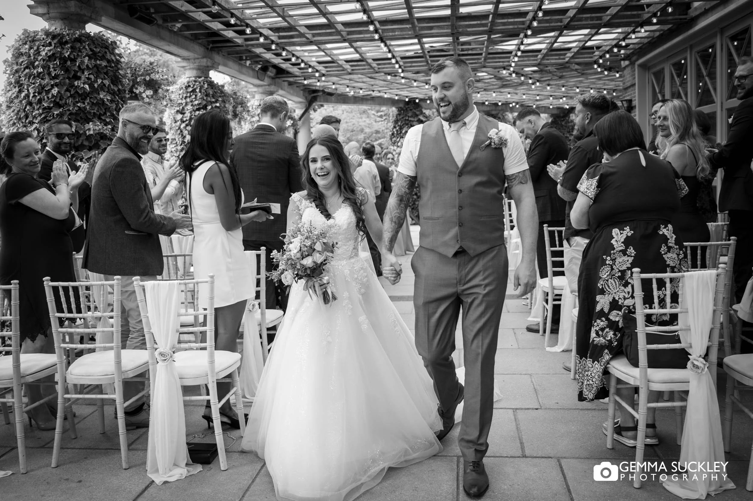 just married couple walking up the aisle at sun pavilion