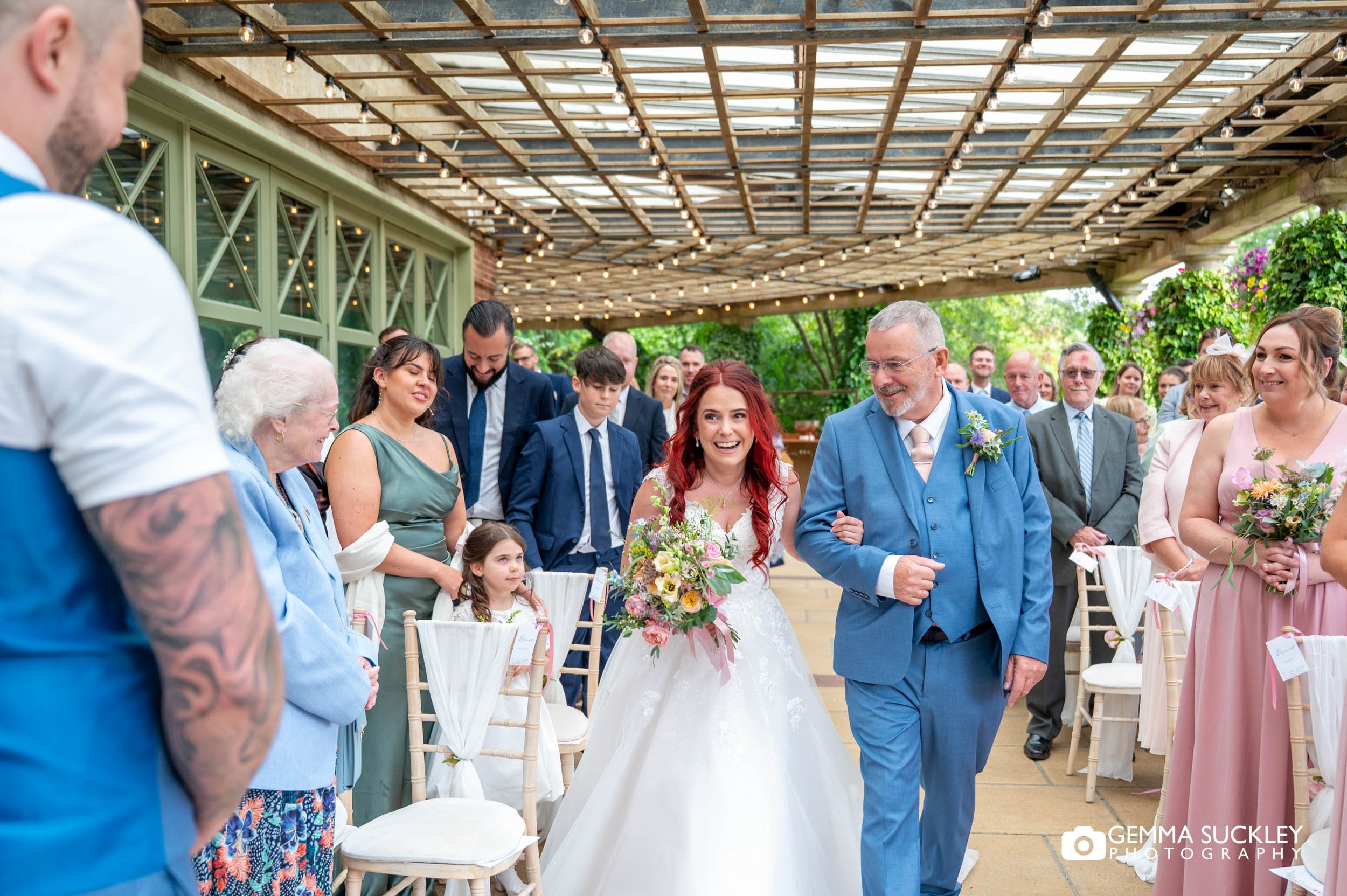 Bride walking down the aisle with her dad at The Sun Pavilion Harrogate