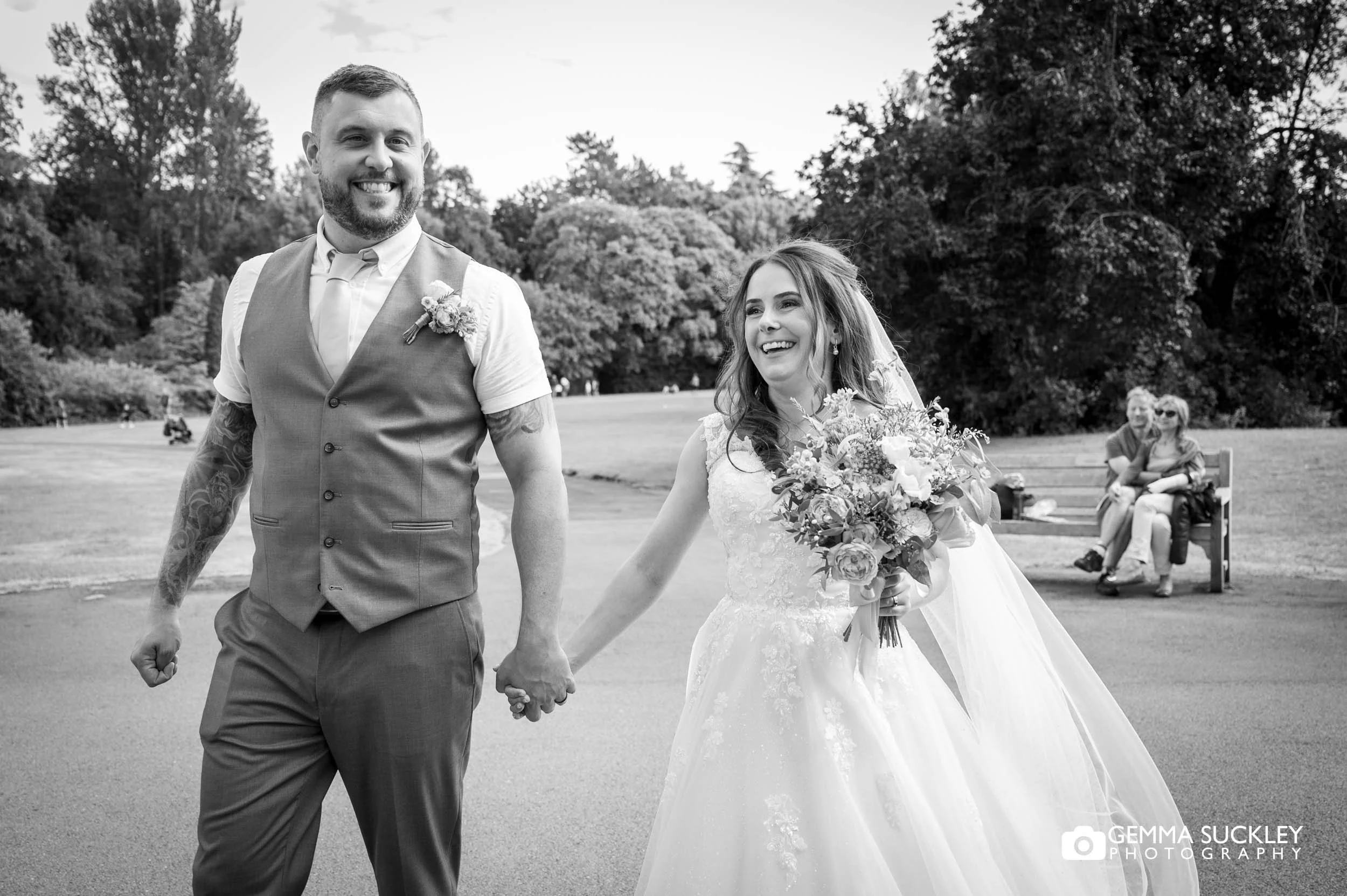 Bride and groom laughing together during their wedding portraits