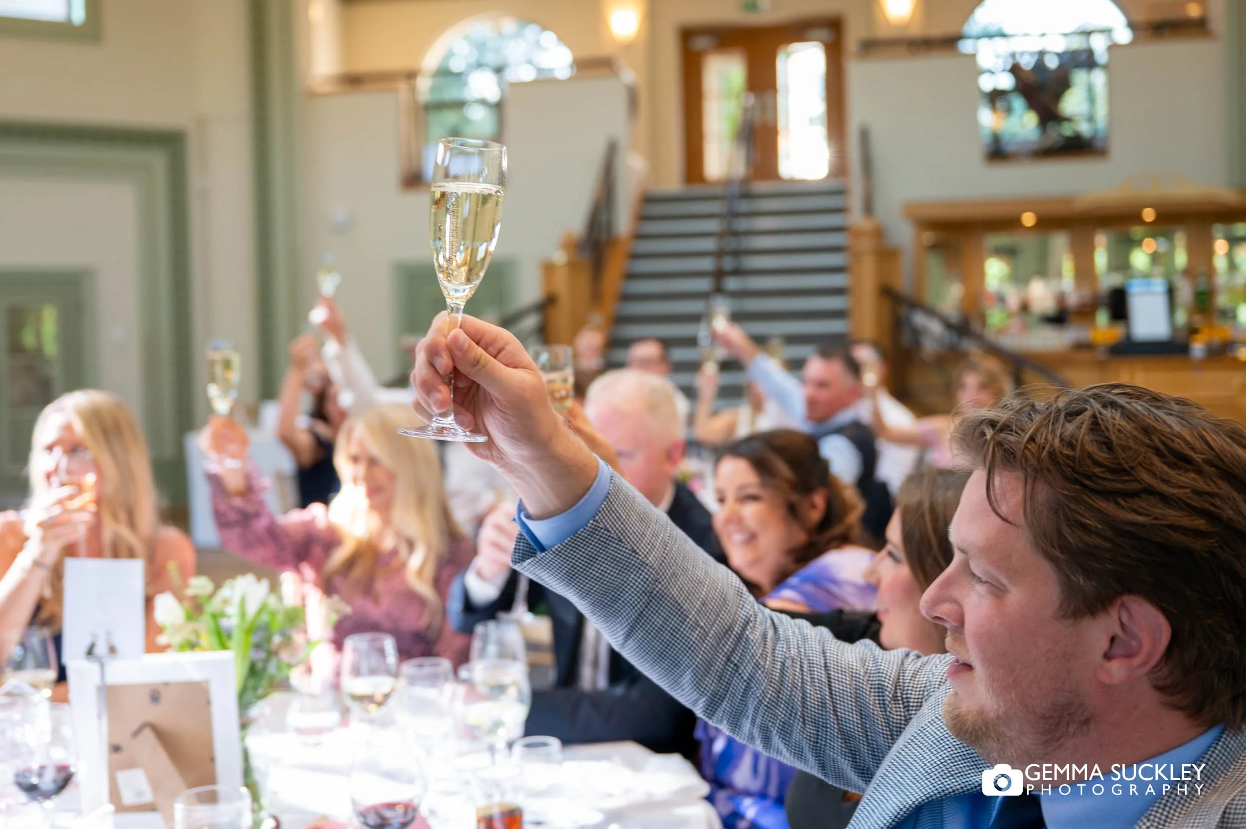 wedding guests toasting at the end of the speeches