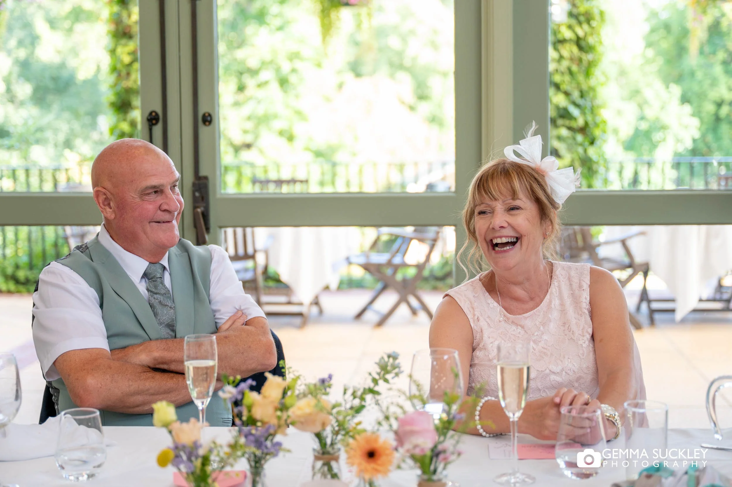 Guests listening to the speeches at the wedding reception
